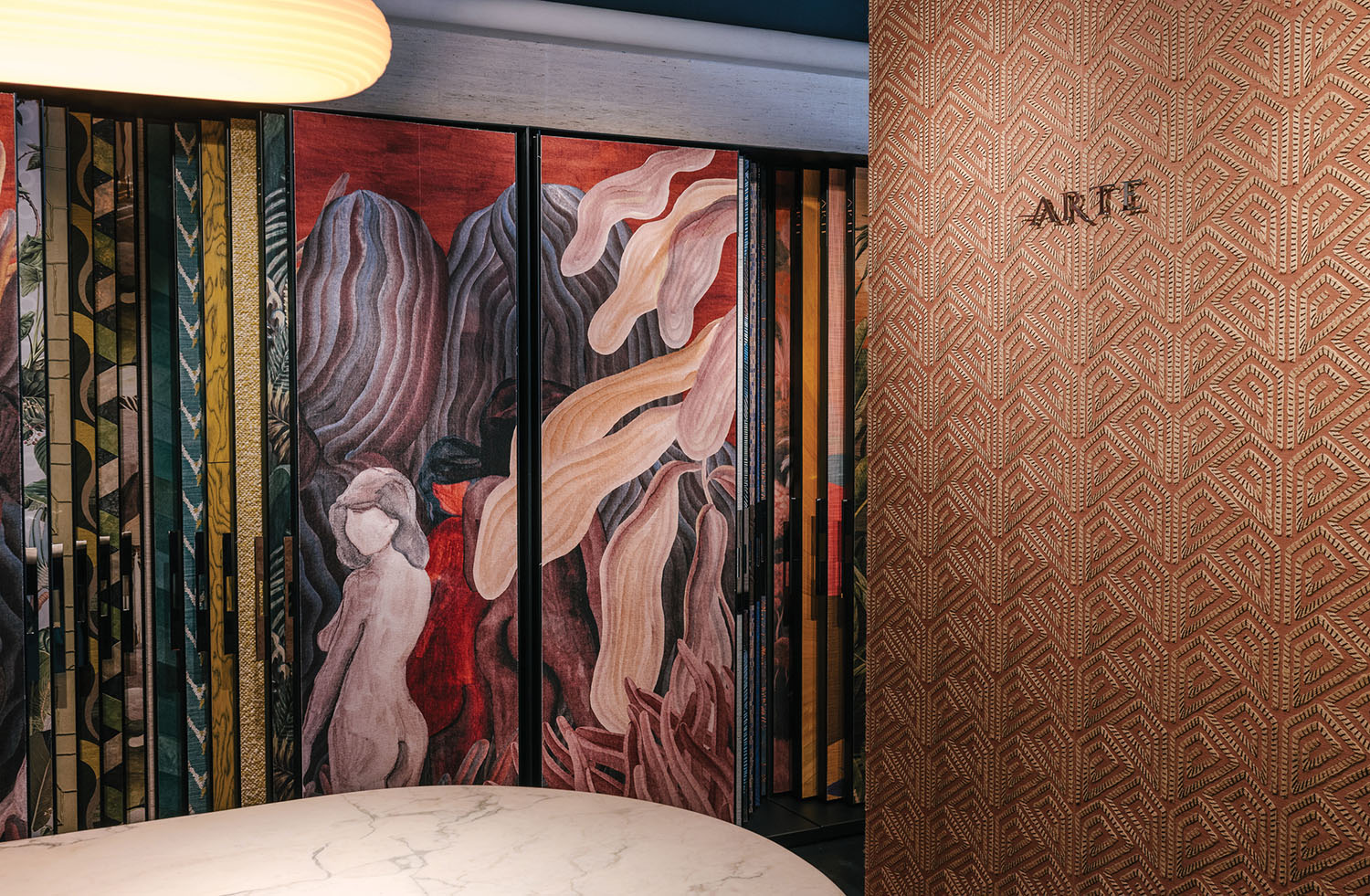 A bathroom with a marble counter and a wall with a painting.