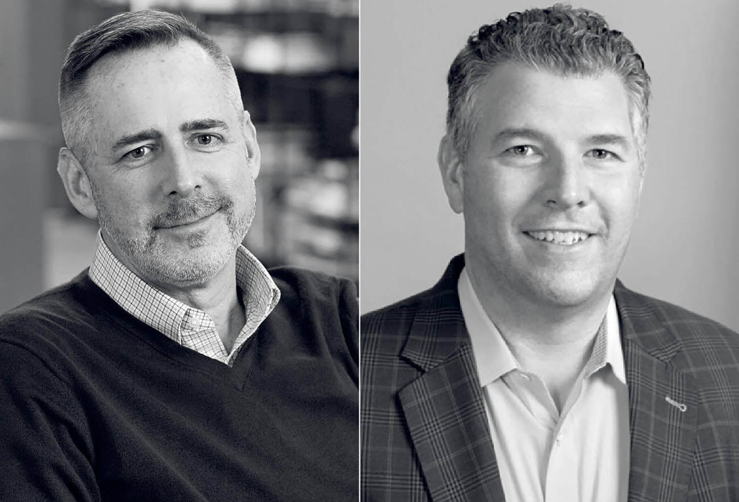 Two men in black and white, one is smiling.