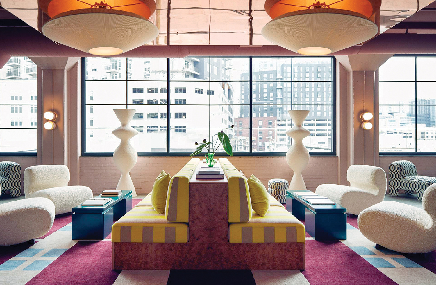 a room with a large window and a colorful rug