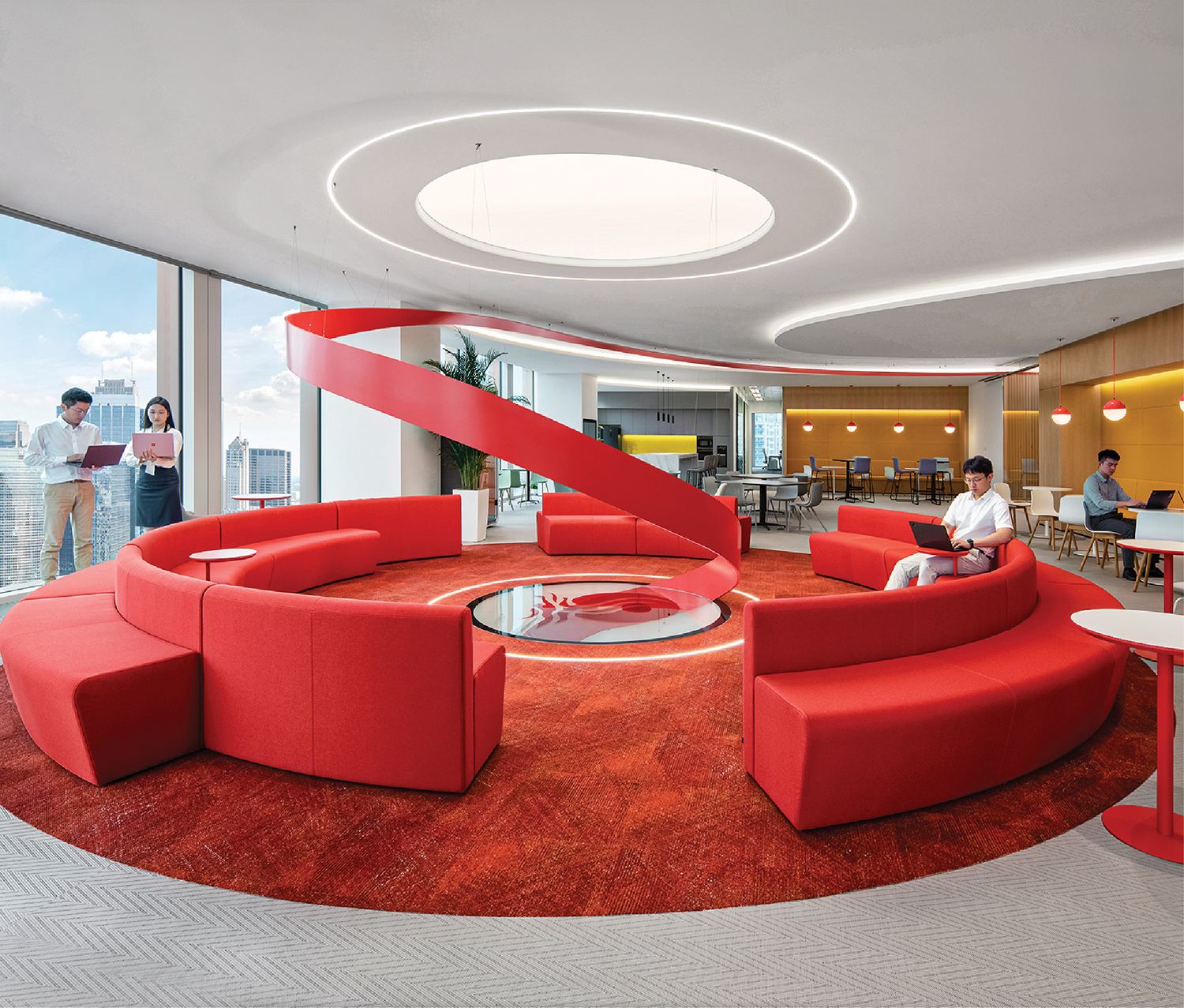 a red circular couch in a modern office
