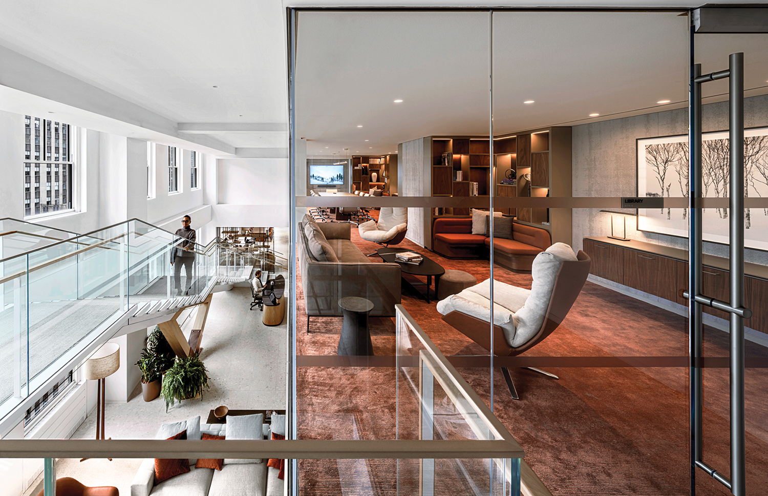 a living room with a glass railing and a couch