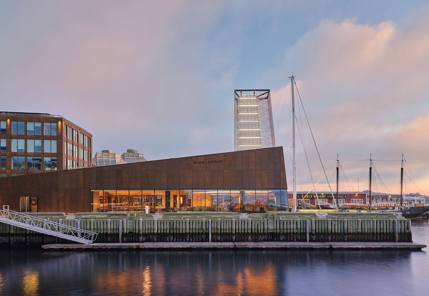 The waterfront at dusk with the city skyline in the background