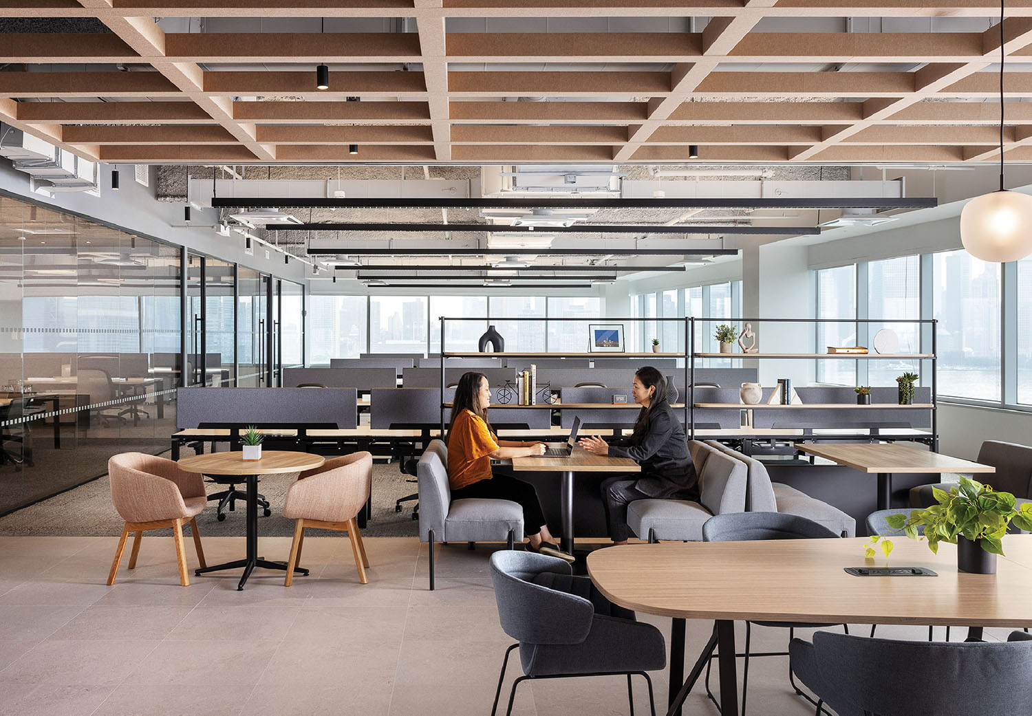 A woman sitting at a table in an office