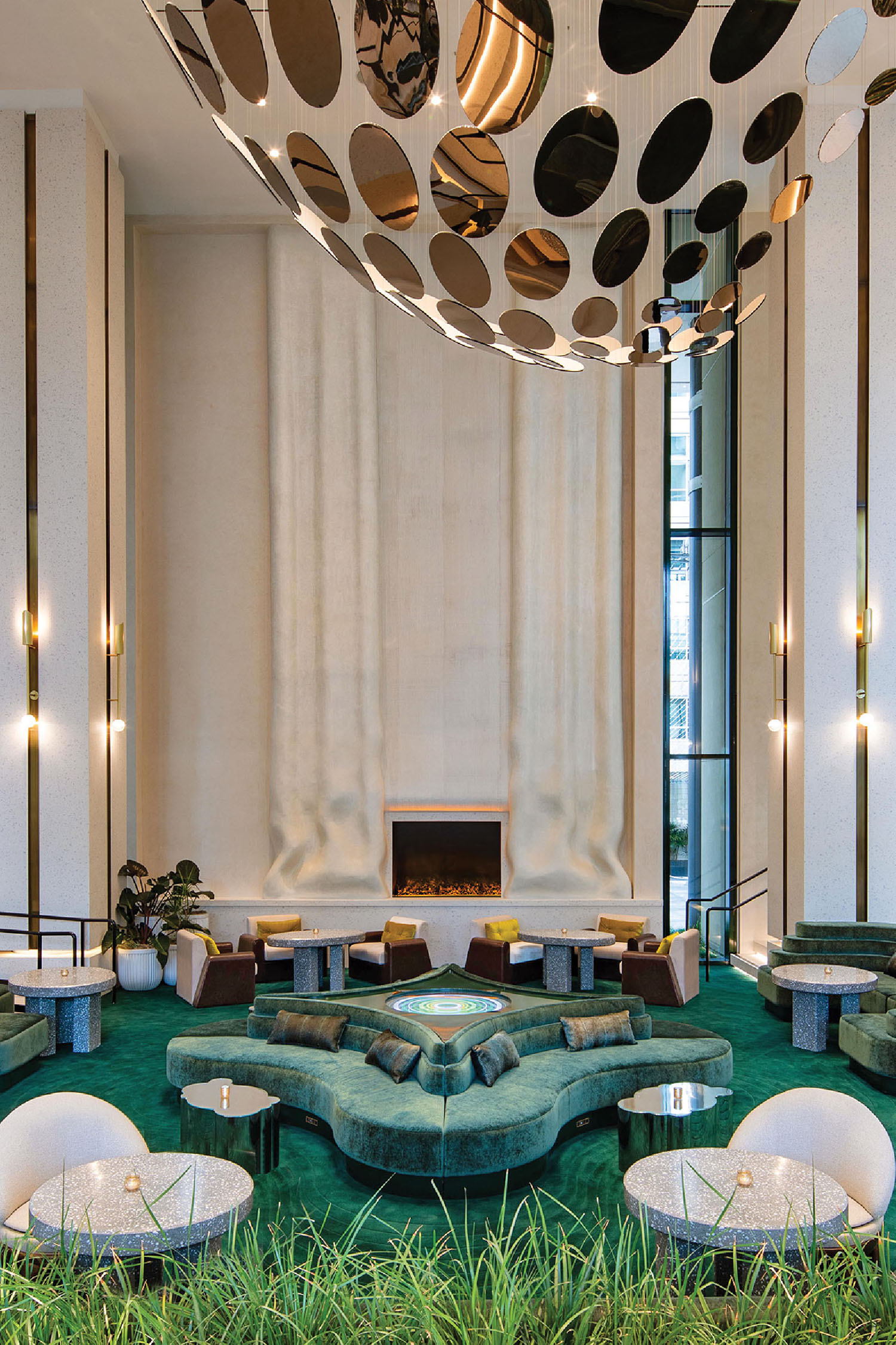 A living room with a large green rug