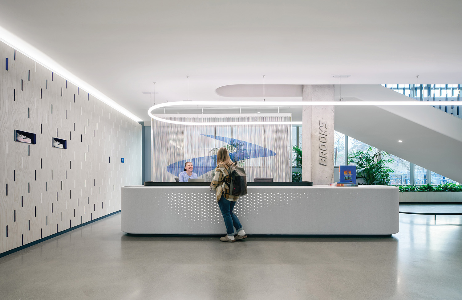 A woman standing at the front desk of a building