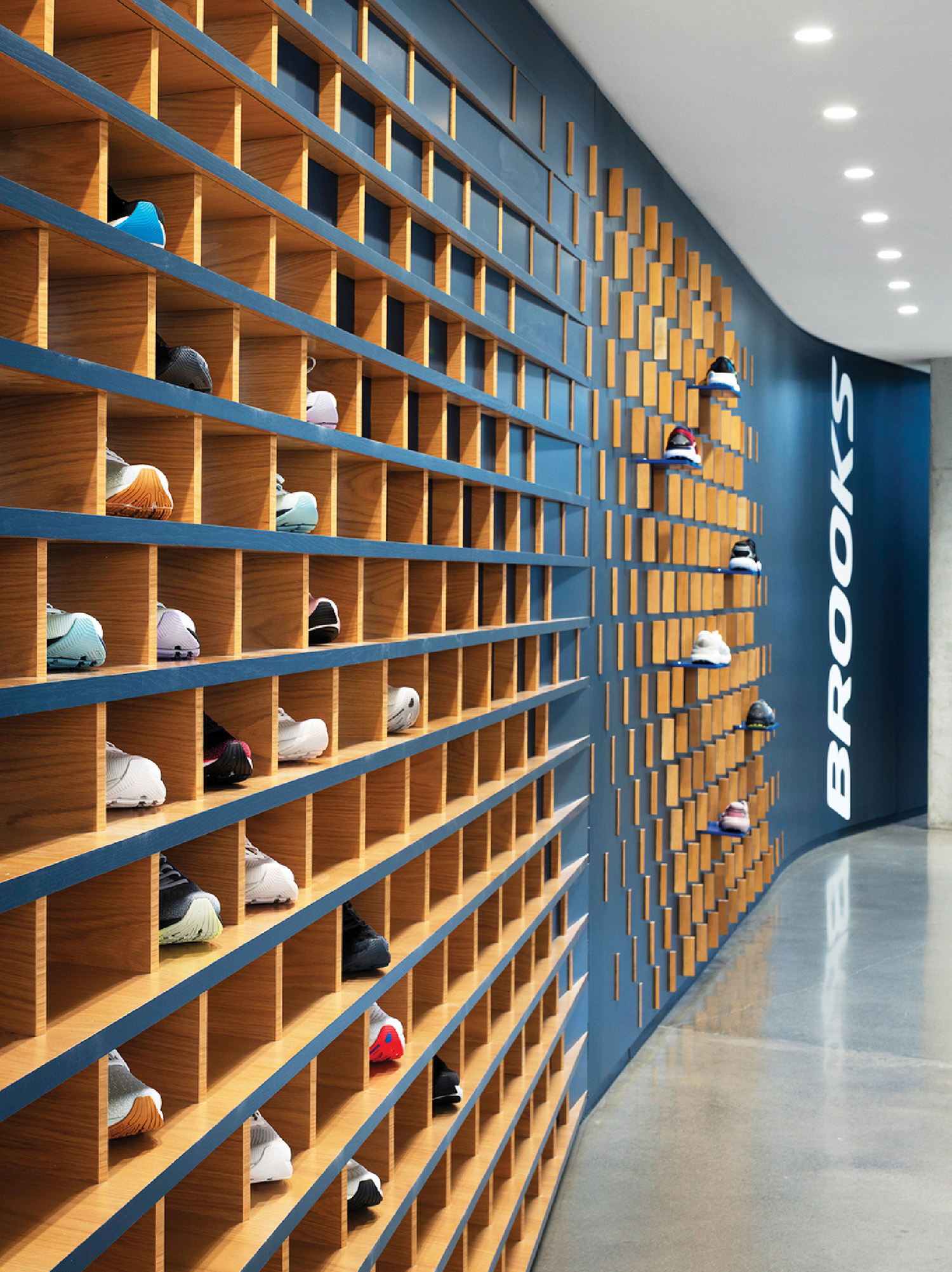 A wall of wooden shelves with hats on them