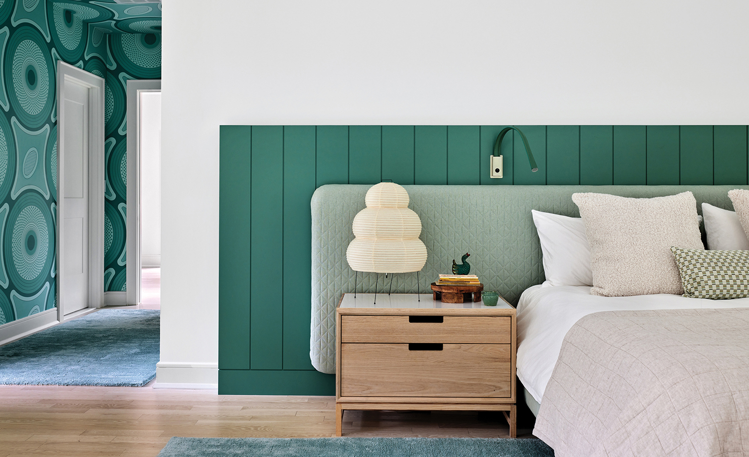 A bedroom with a bed and a nightstand.