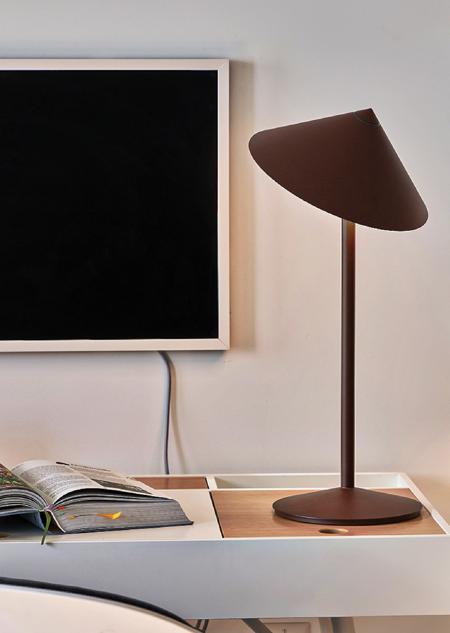 A lamp on a table with a book and a book.