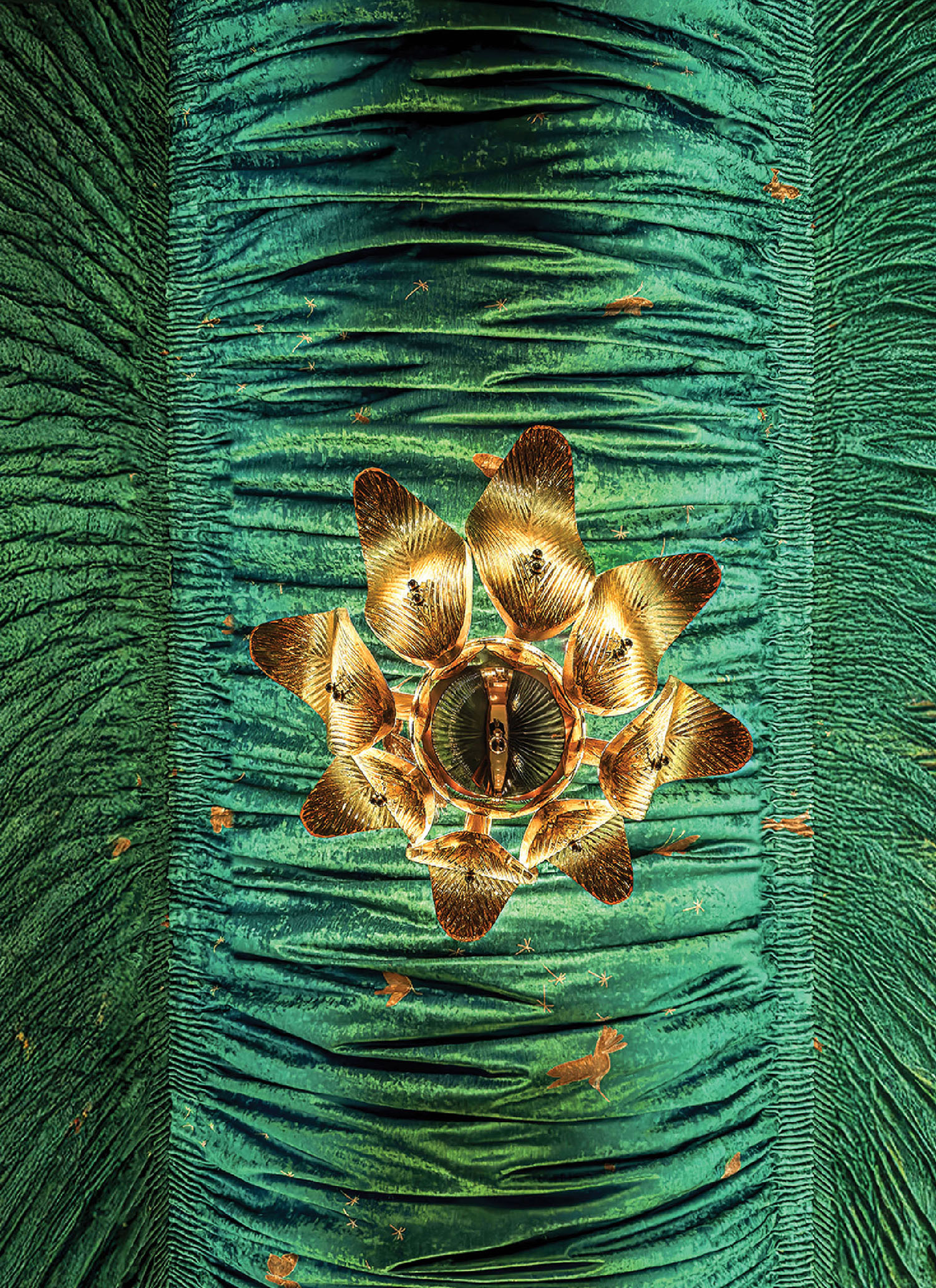 A green and gold wallpaper with a flower.