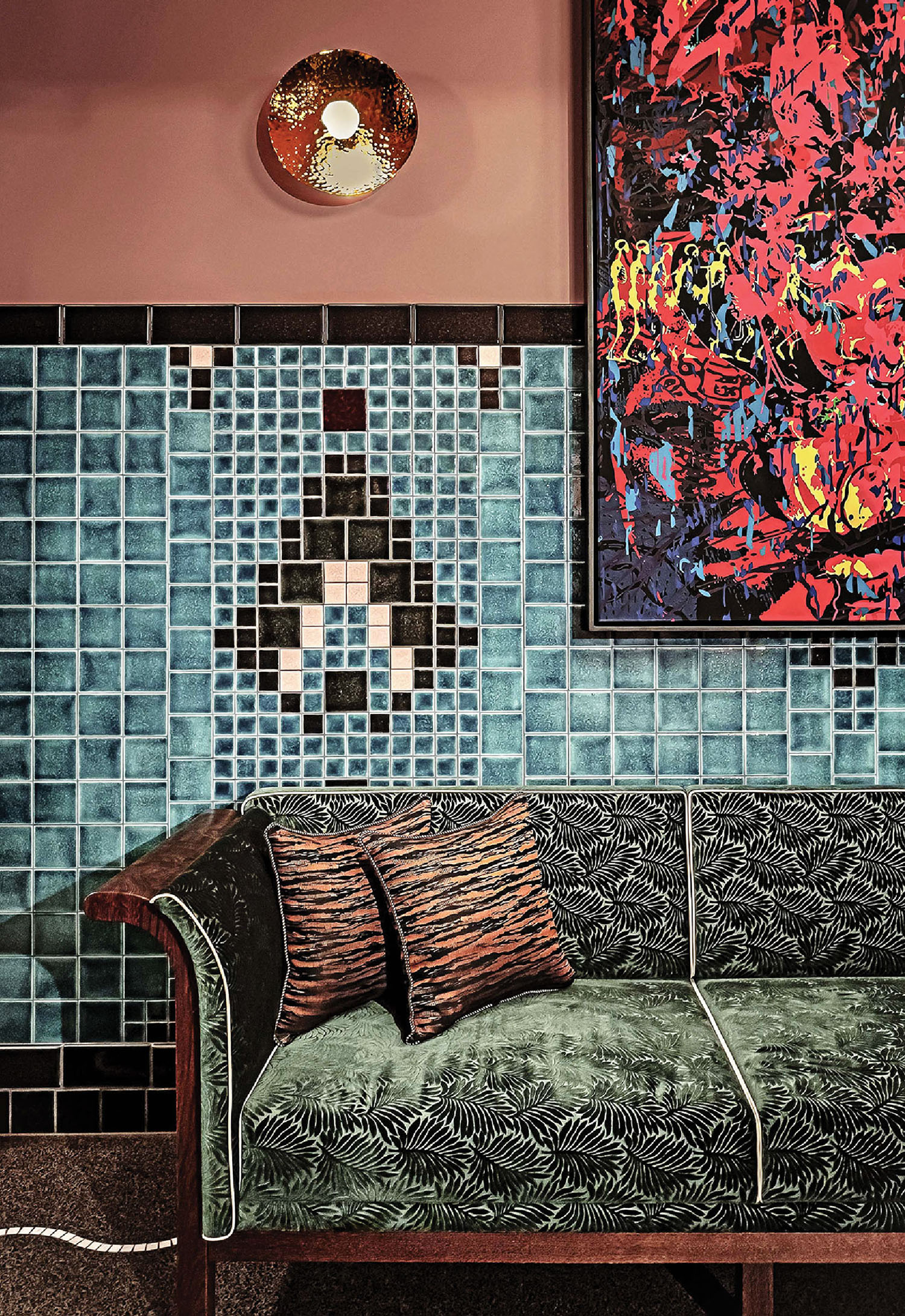 A couch with a painting on the wall.