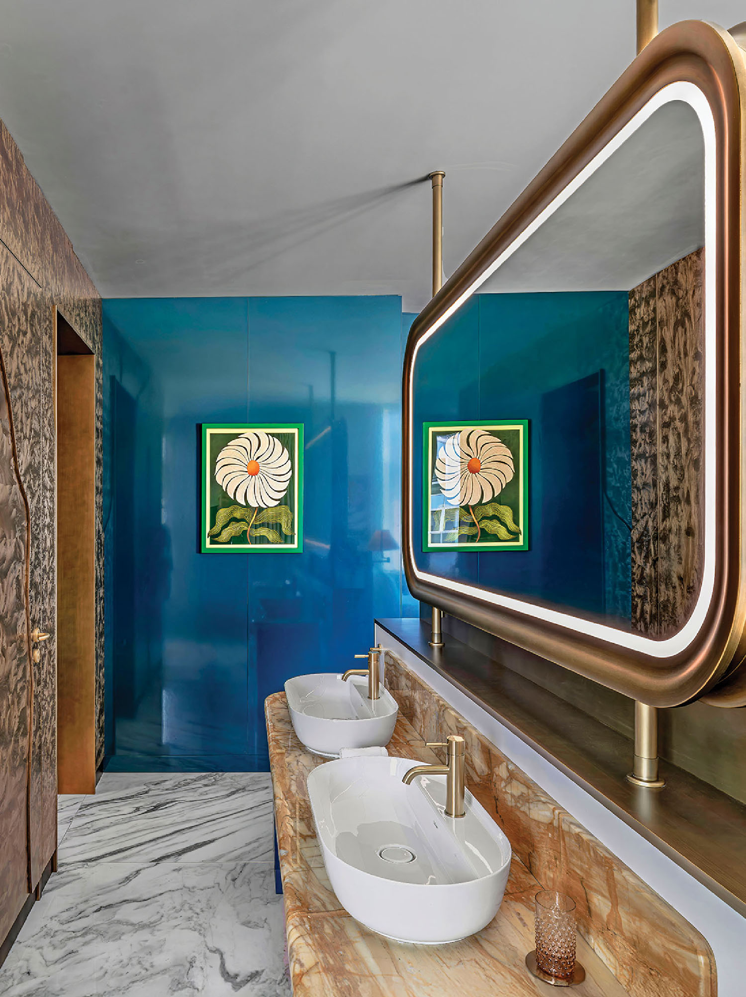 A bathroom with a marble counter and a mirror.