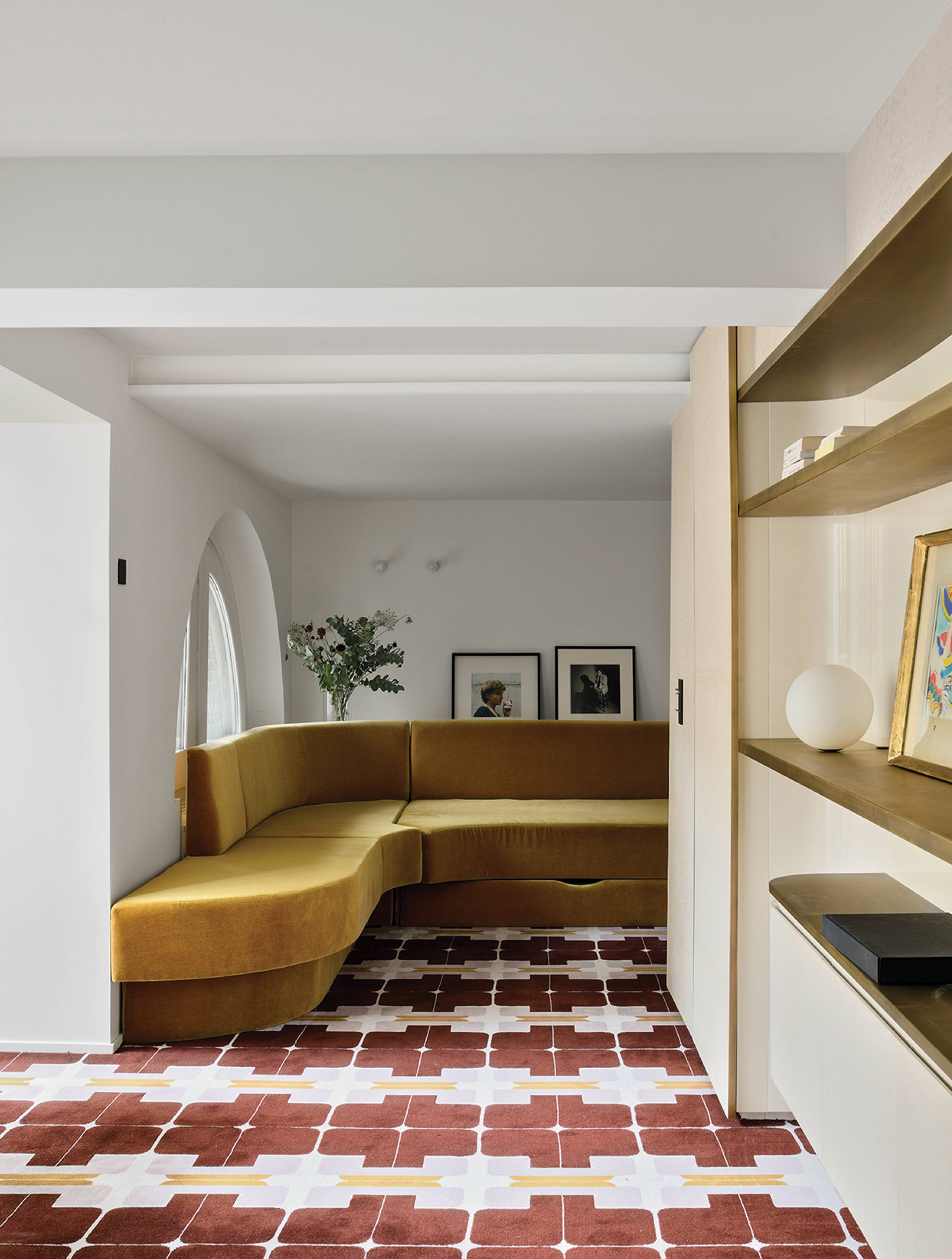 A living room with a couch and a shelf