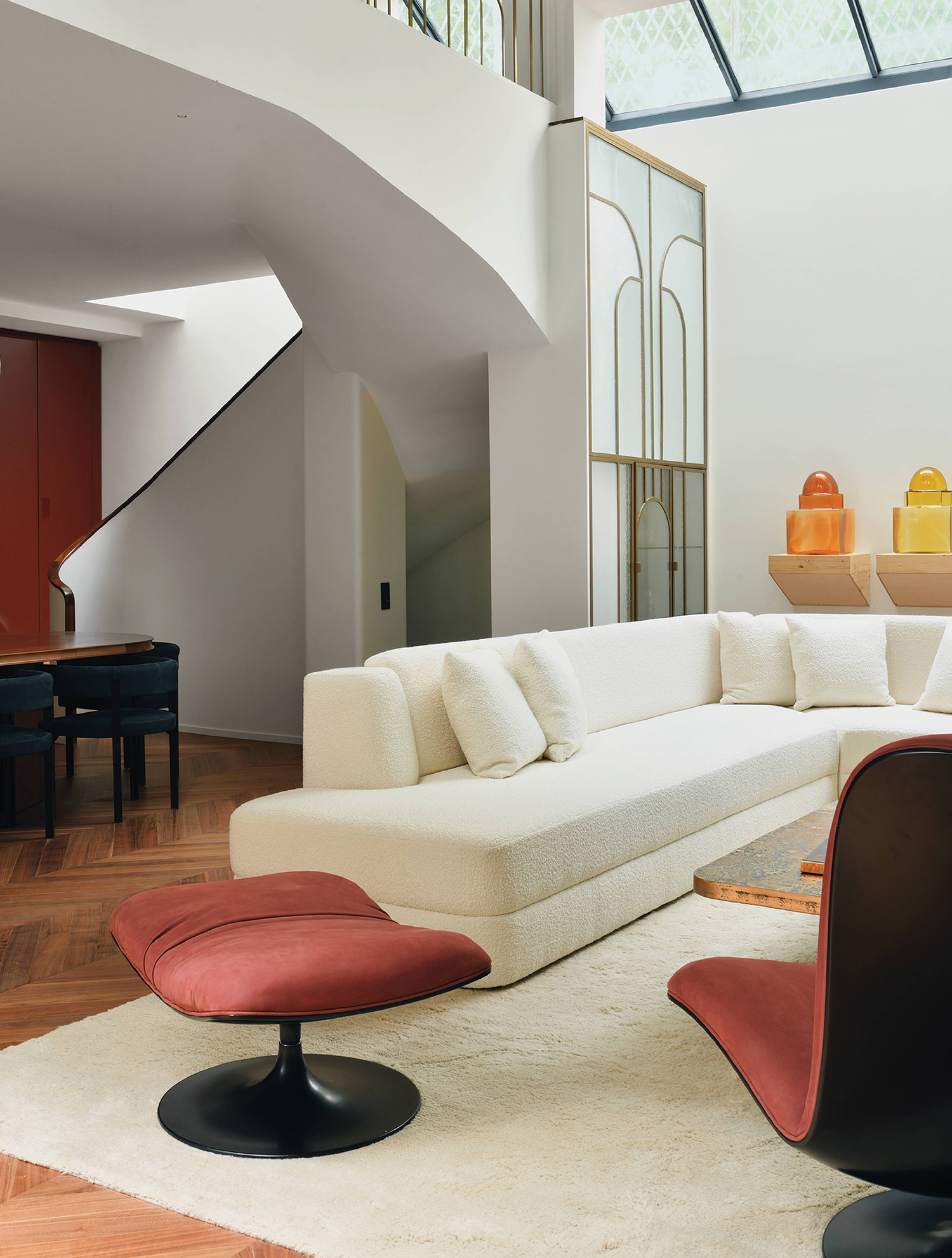 A living room with a white couch and a piano
