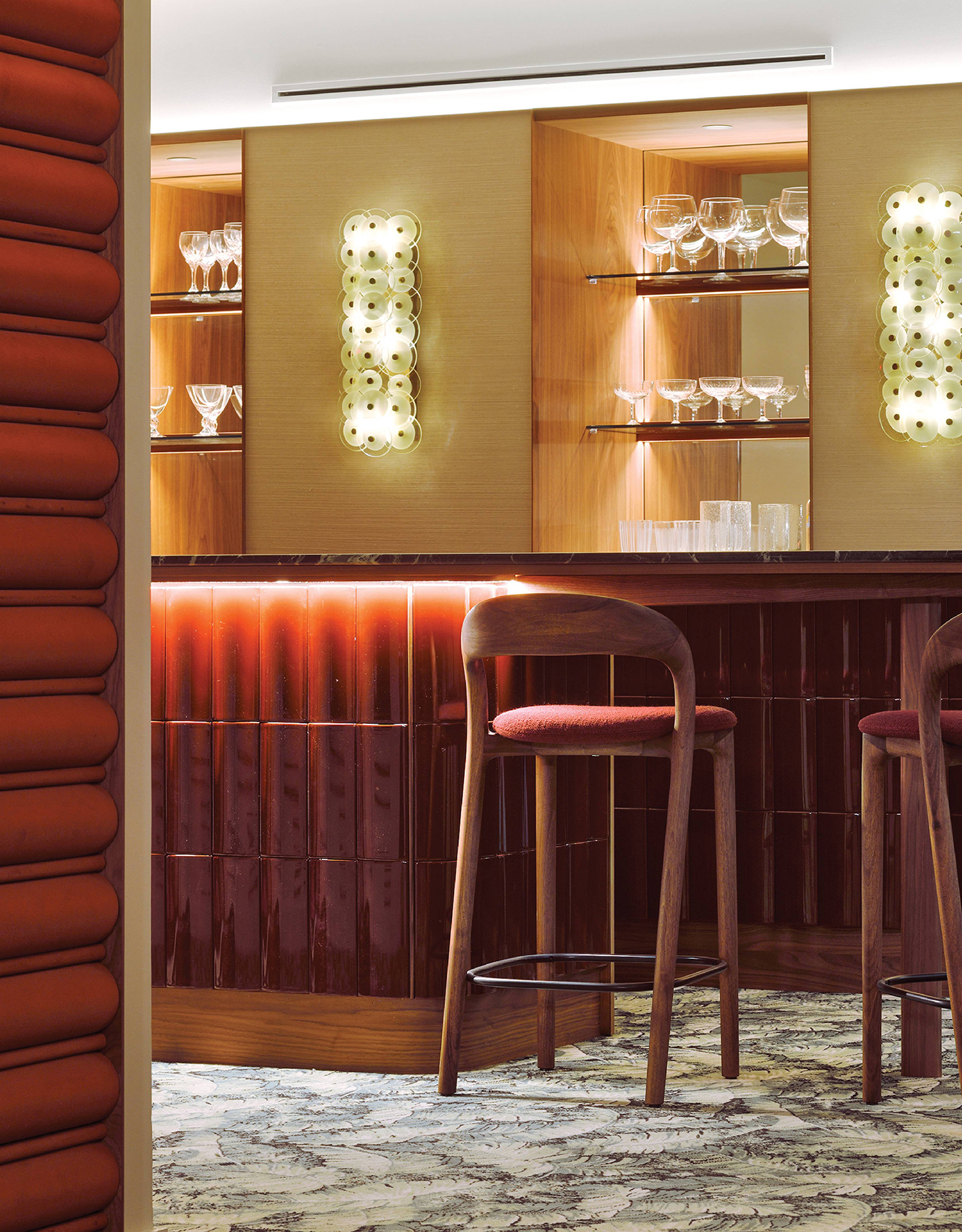 A bar with a bunch of wine glasses on the wall