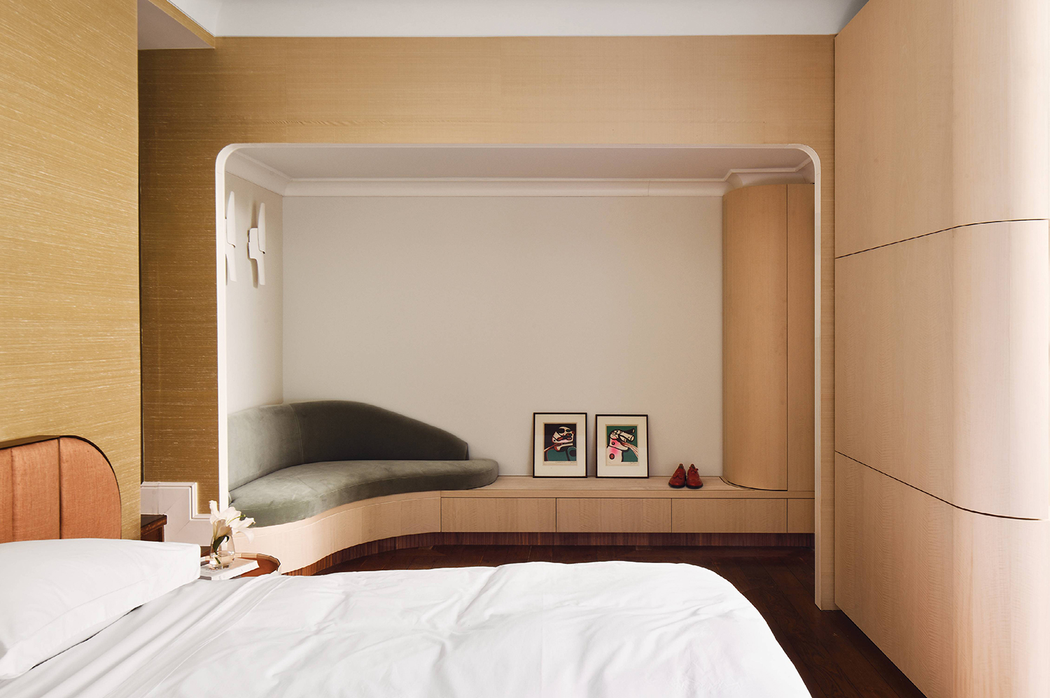 A bedroom with a bed and a small desk