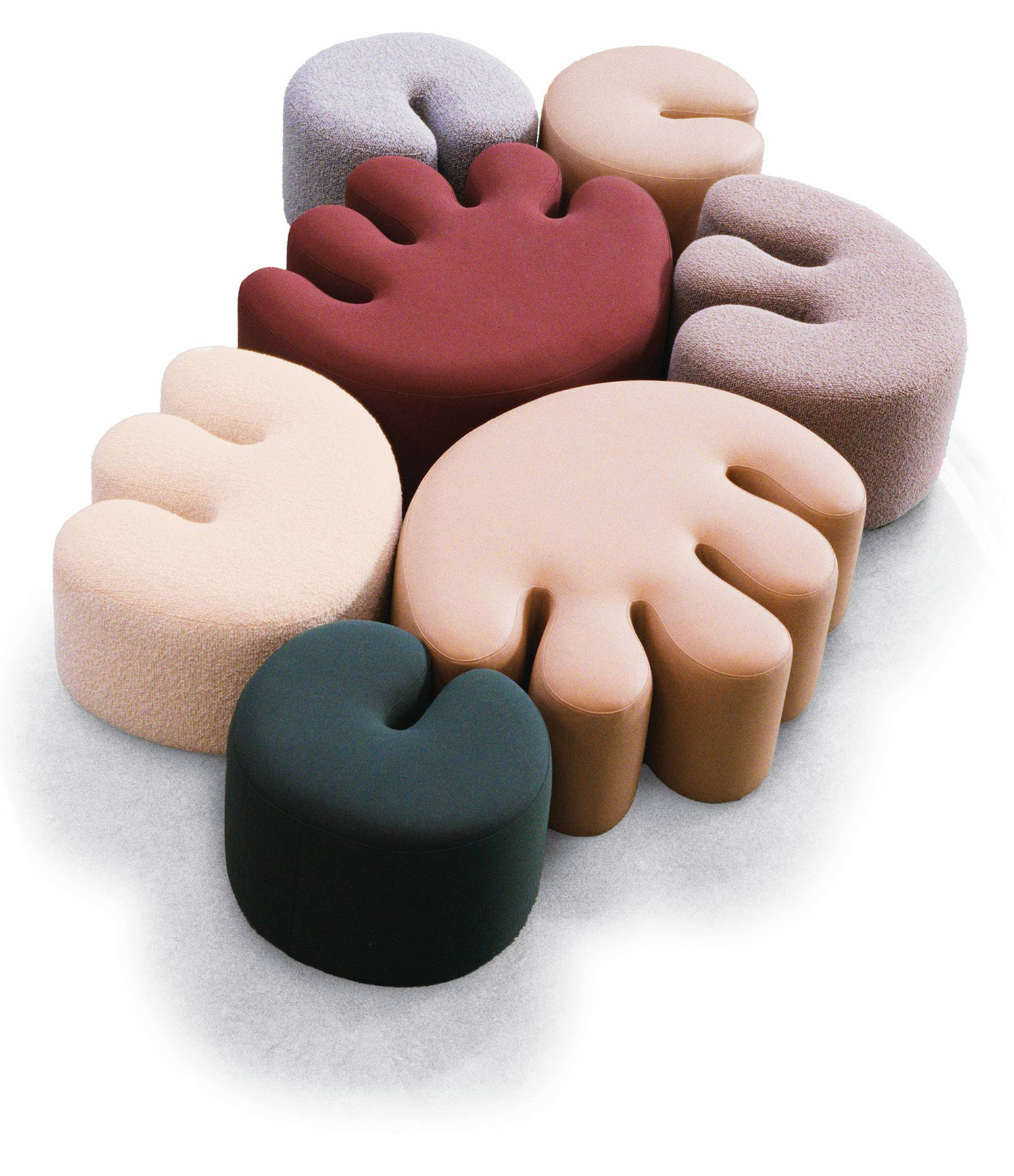 A pile of different colored pillows.