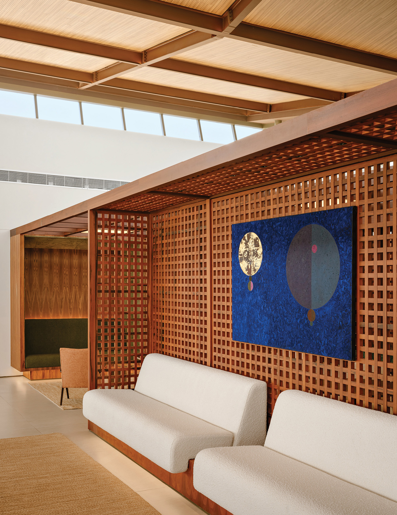 A living room with a couch and a painting on the wall