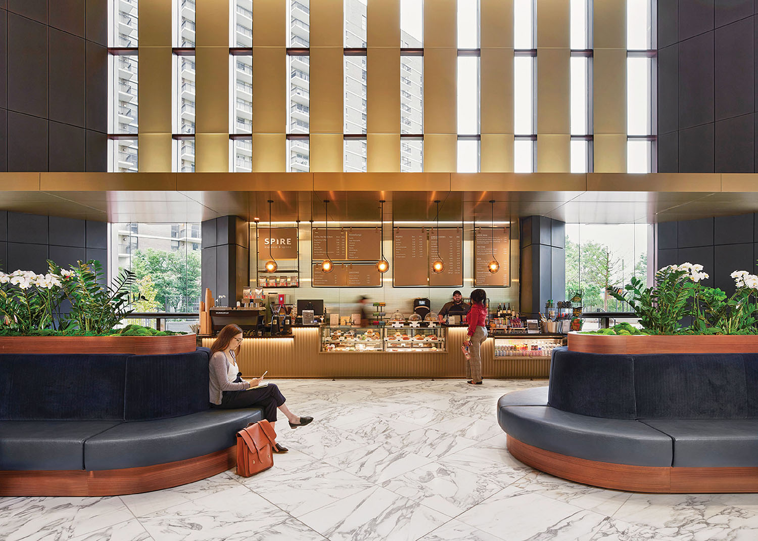 A woman sitting on a couch in a lobby