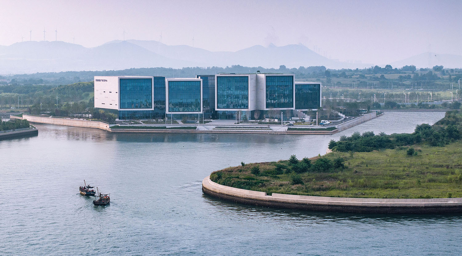 A boat is in the water near a building