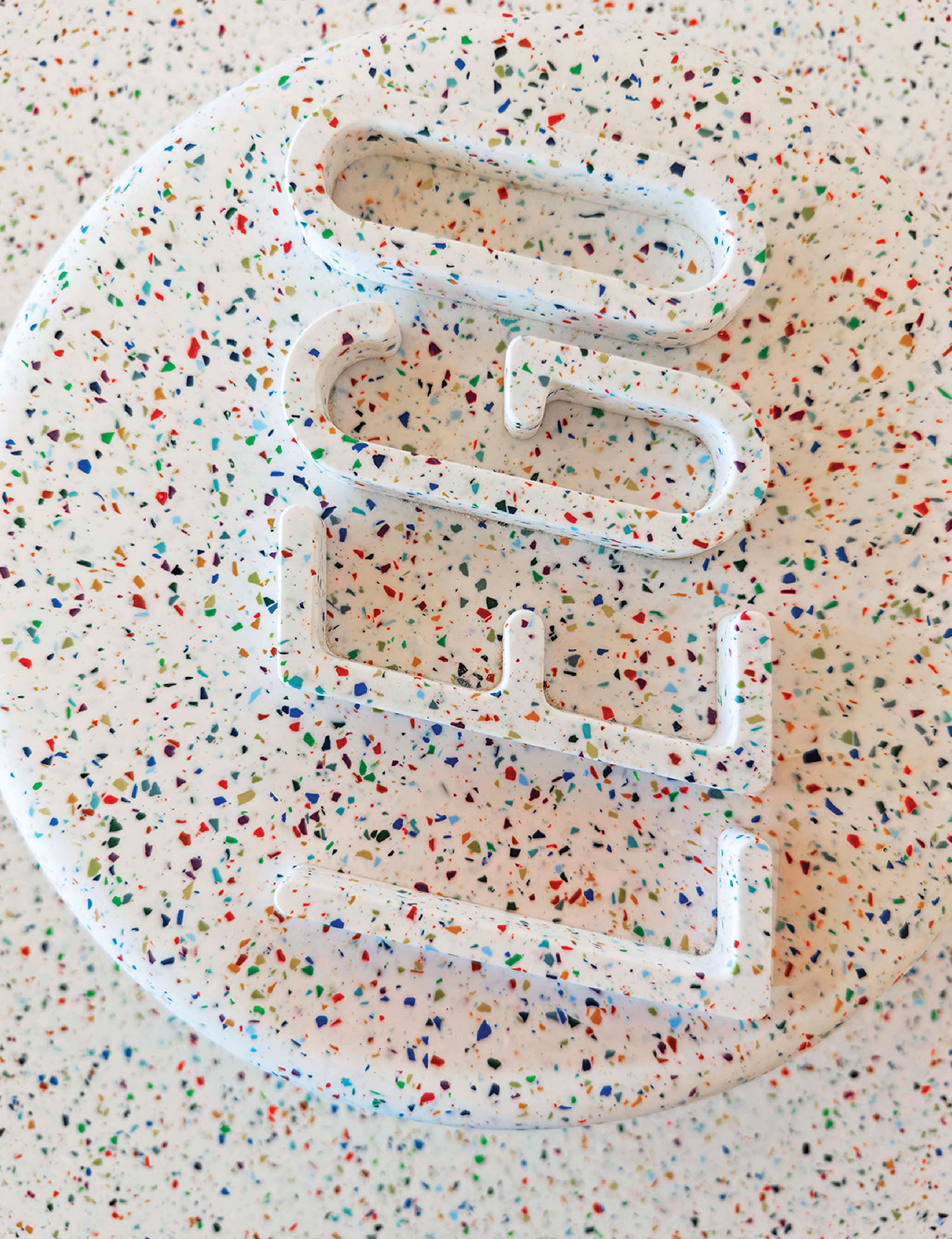 A white plastic object with confettin spe.