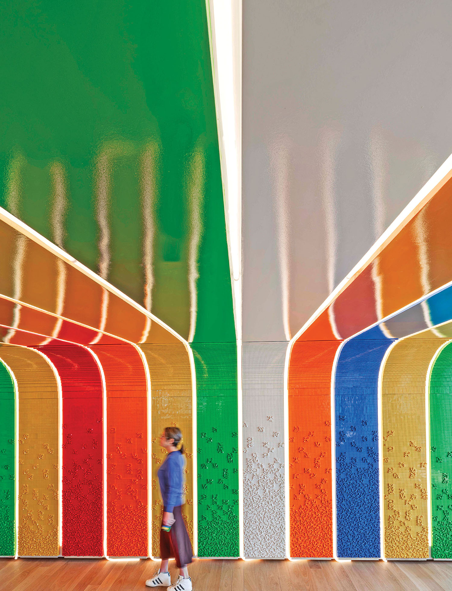 A person walking through a colorful tunnel.