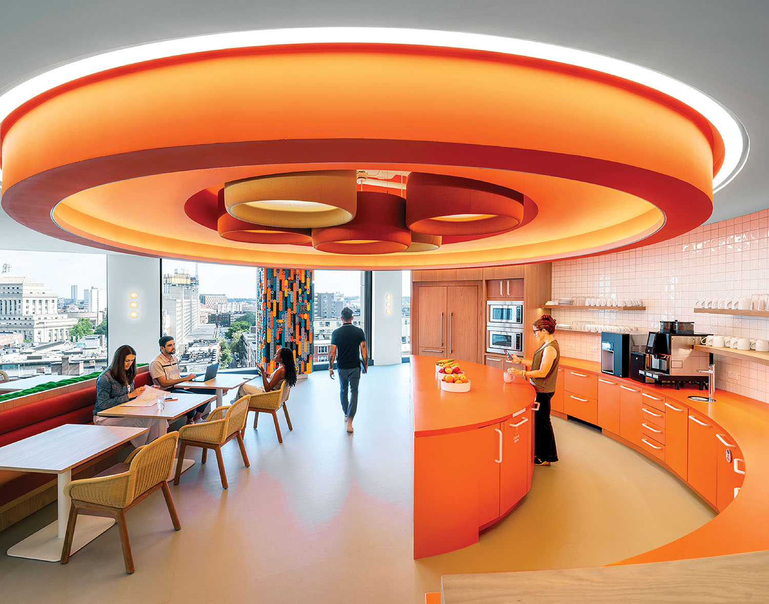 A kitchen with a large orange circular light.