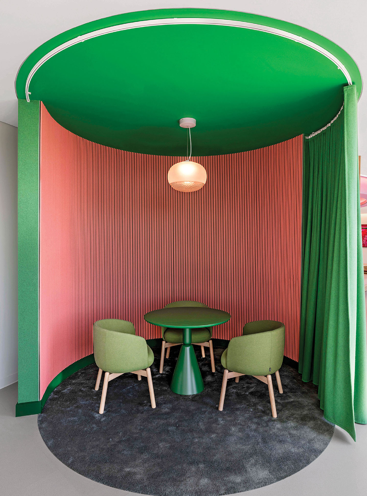 A green table and chairs in a room.