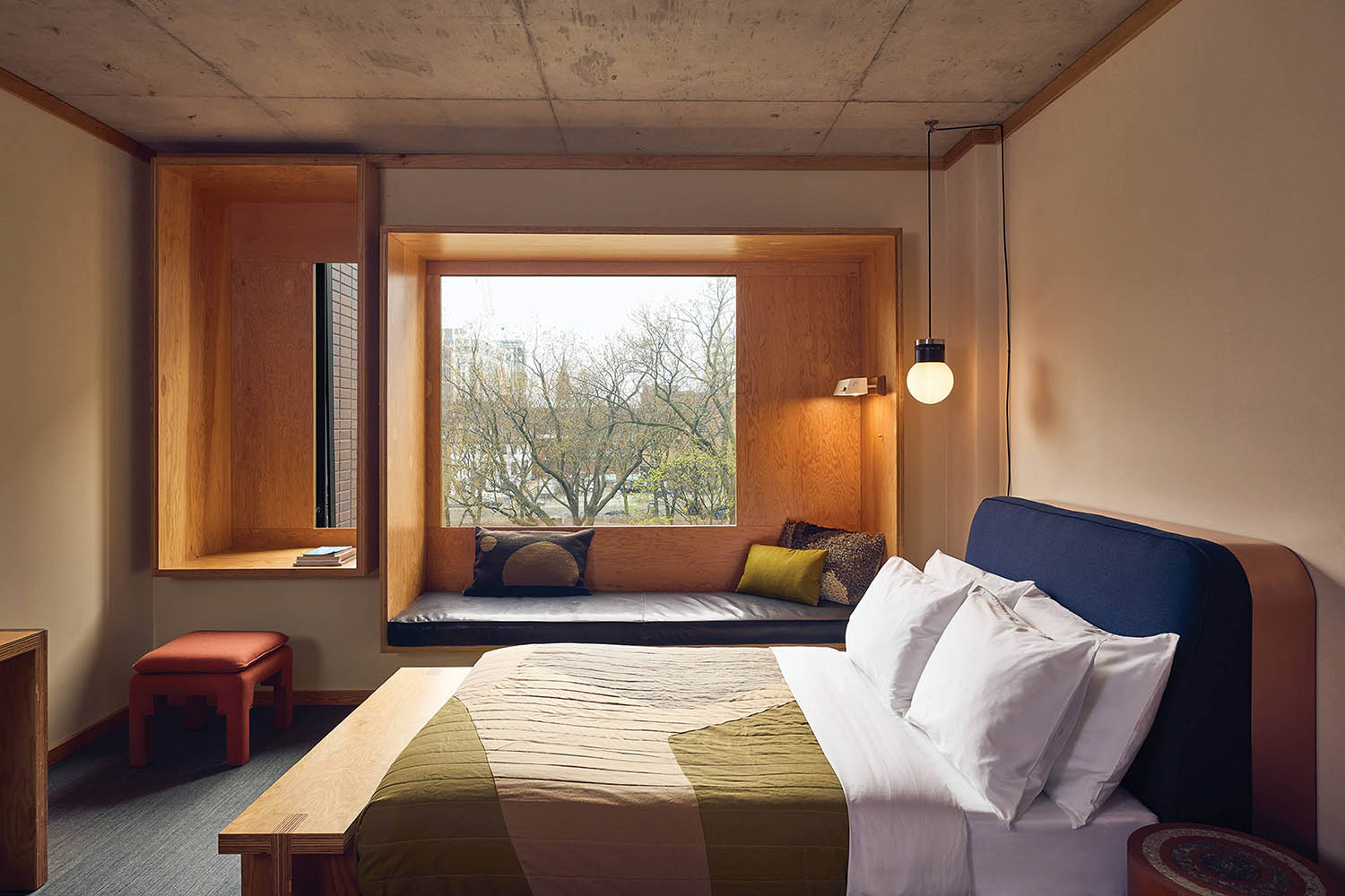 A bedroom with a bed and a window.