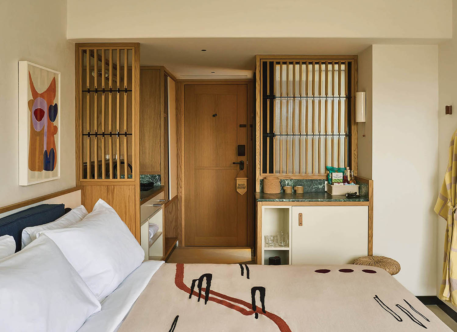 A bedroom with a bed and a desk.