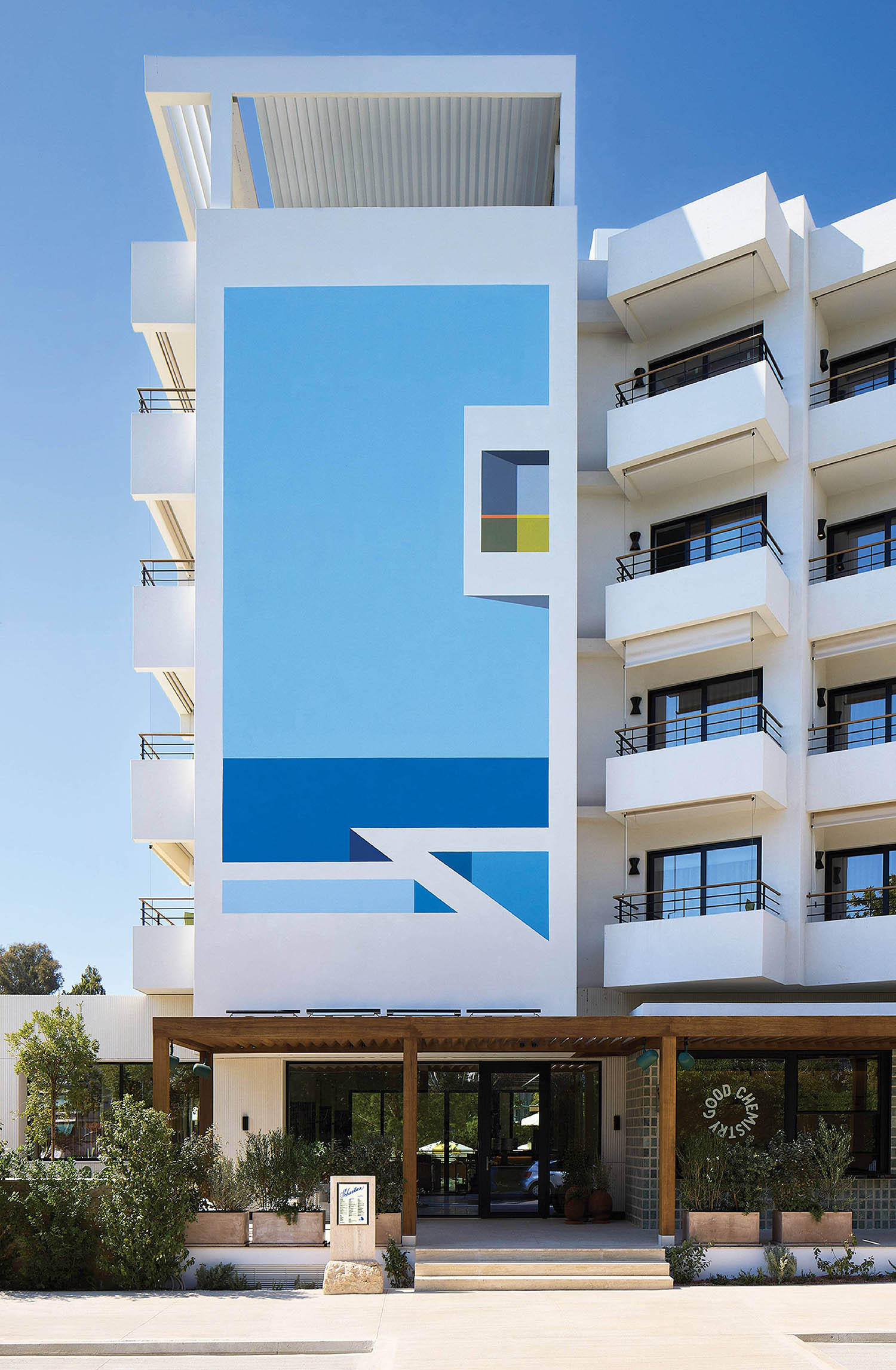 A large white building with blue and green accents.