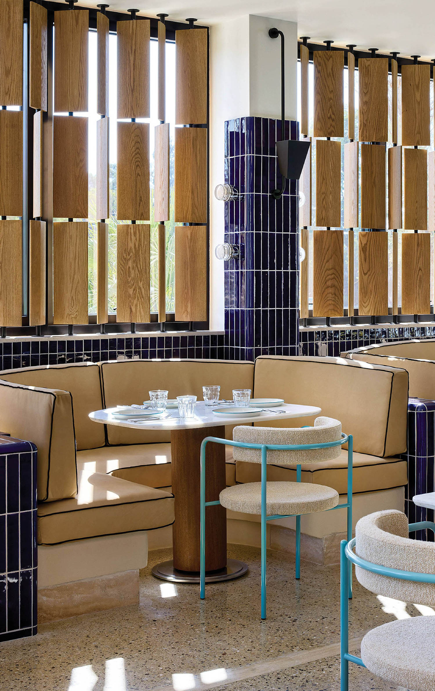 A restaurant with a table and chairs and a wall of windows.