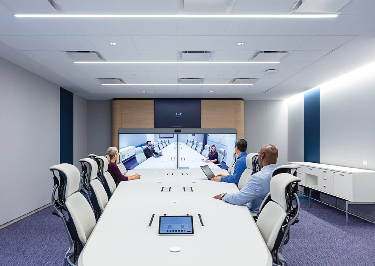 A group of people sitting around a conference table.