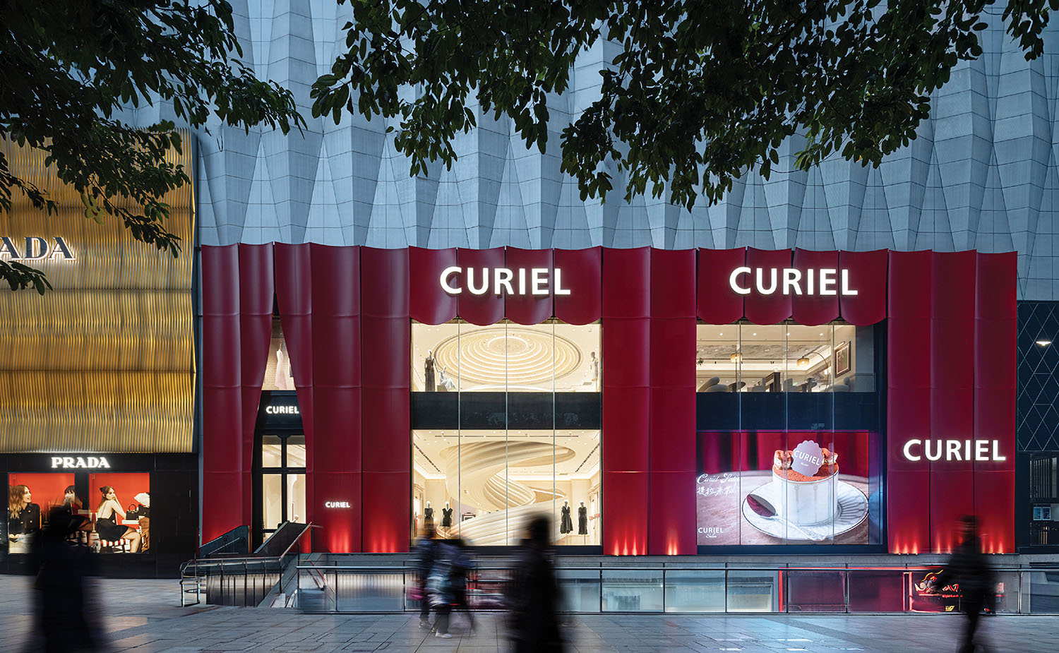 A group of people walking past a building.