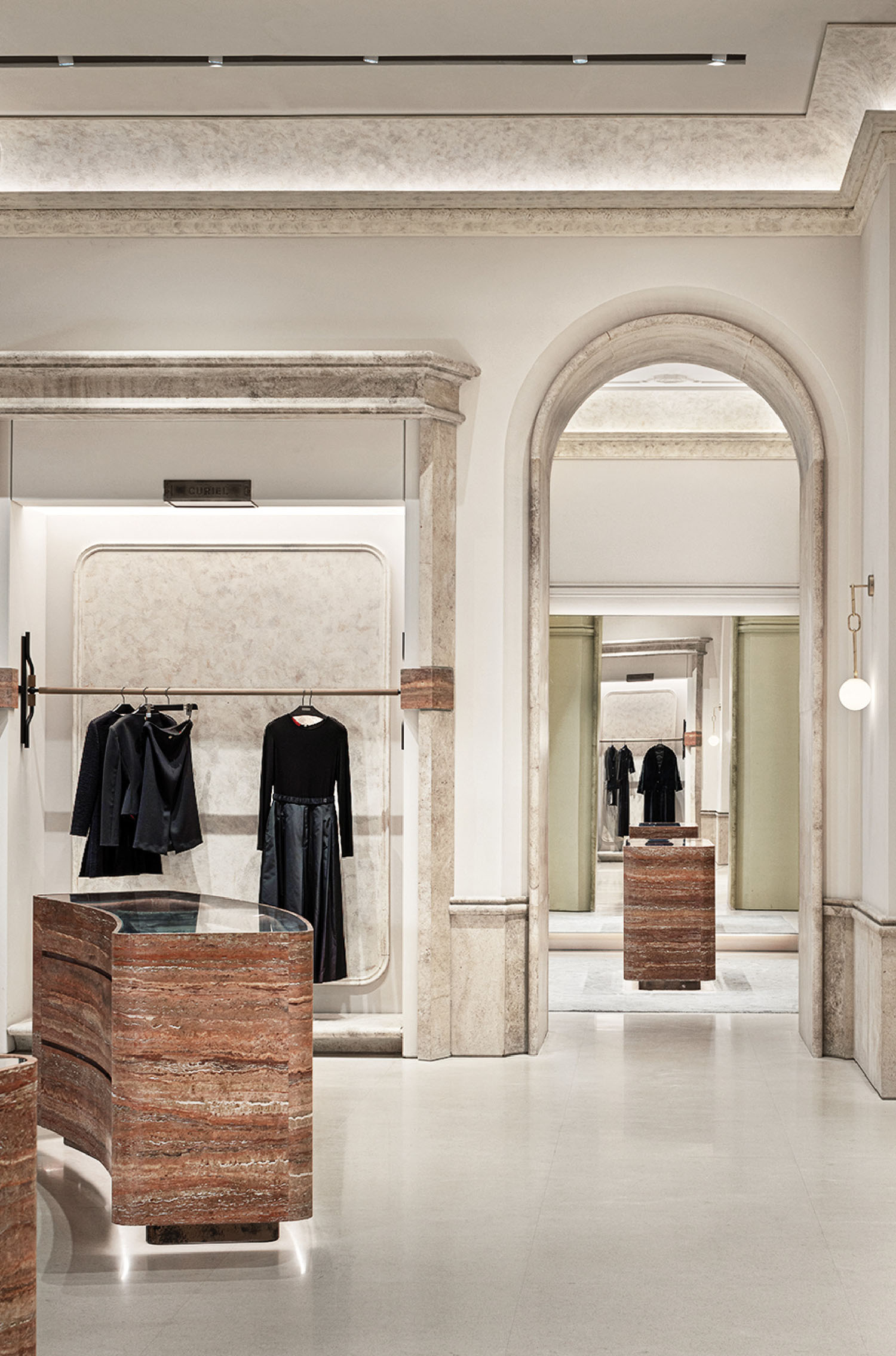 A room with a lot of clothes on display.