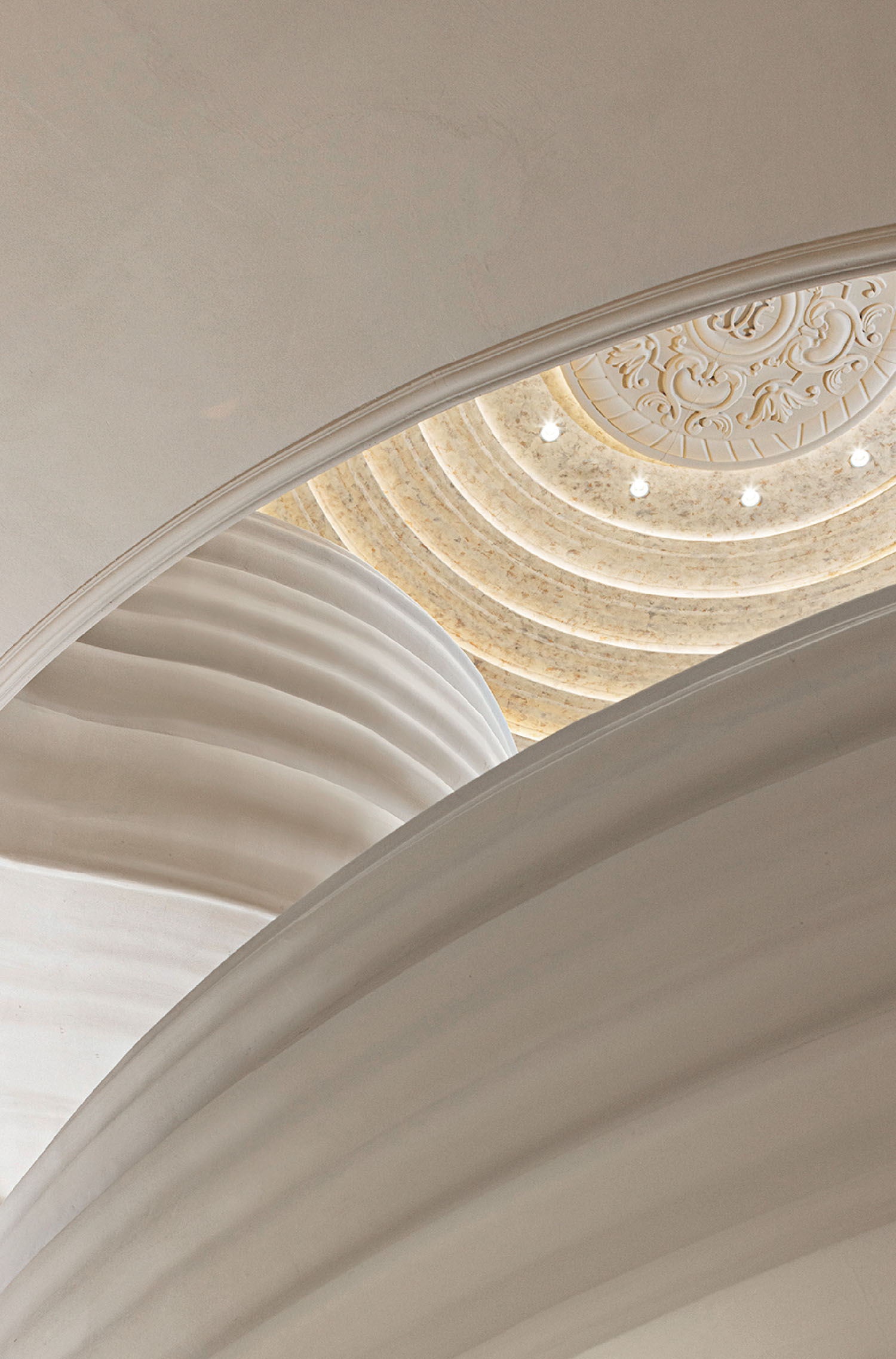 A clock is on the ceiling of a building.
