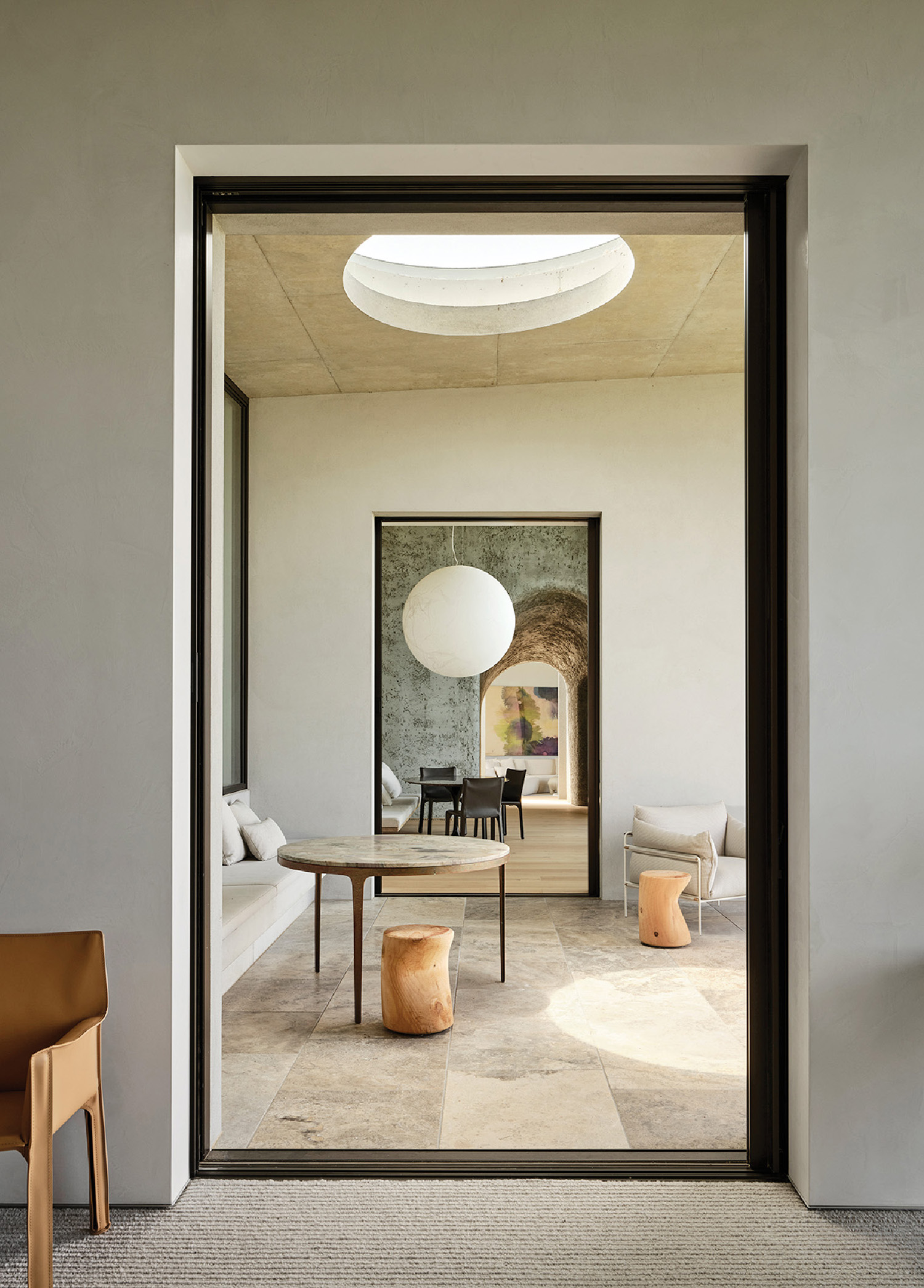 A room with a table and chairs and a mirror