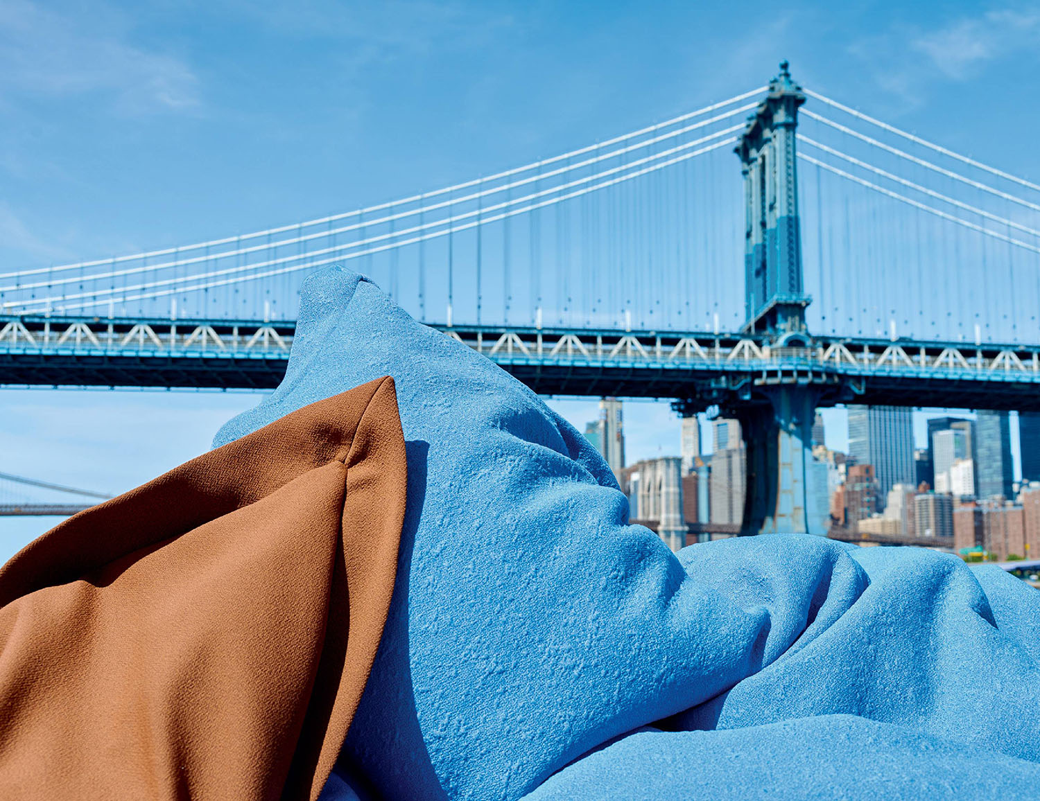 A blanket is folded over a blanket with a view of the brooklyn.