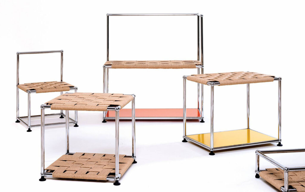 A set of three tables with a wooden top and metal legs.