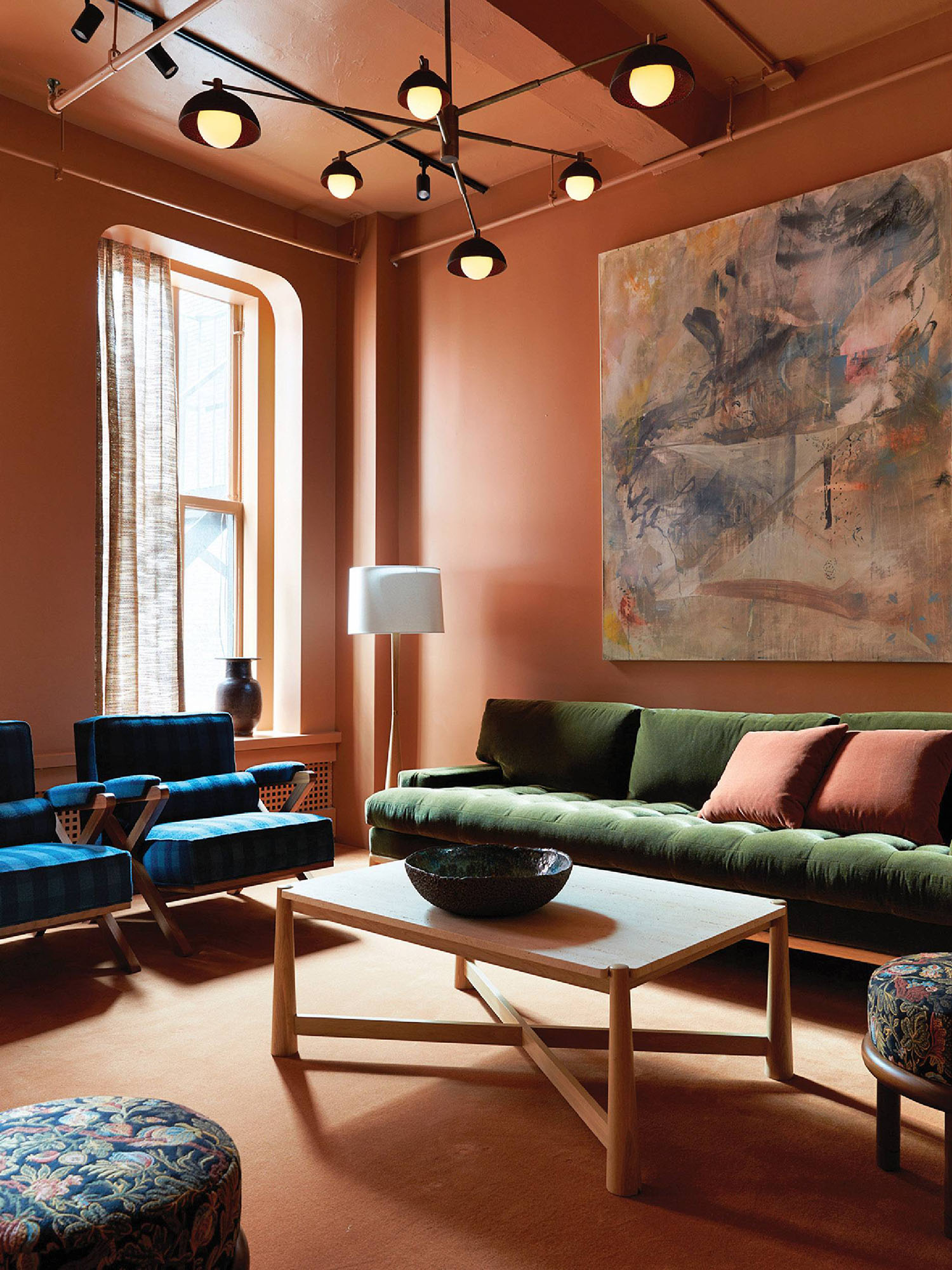 A living room with a couch and a painting.