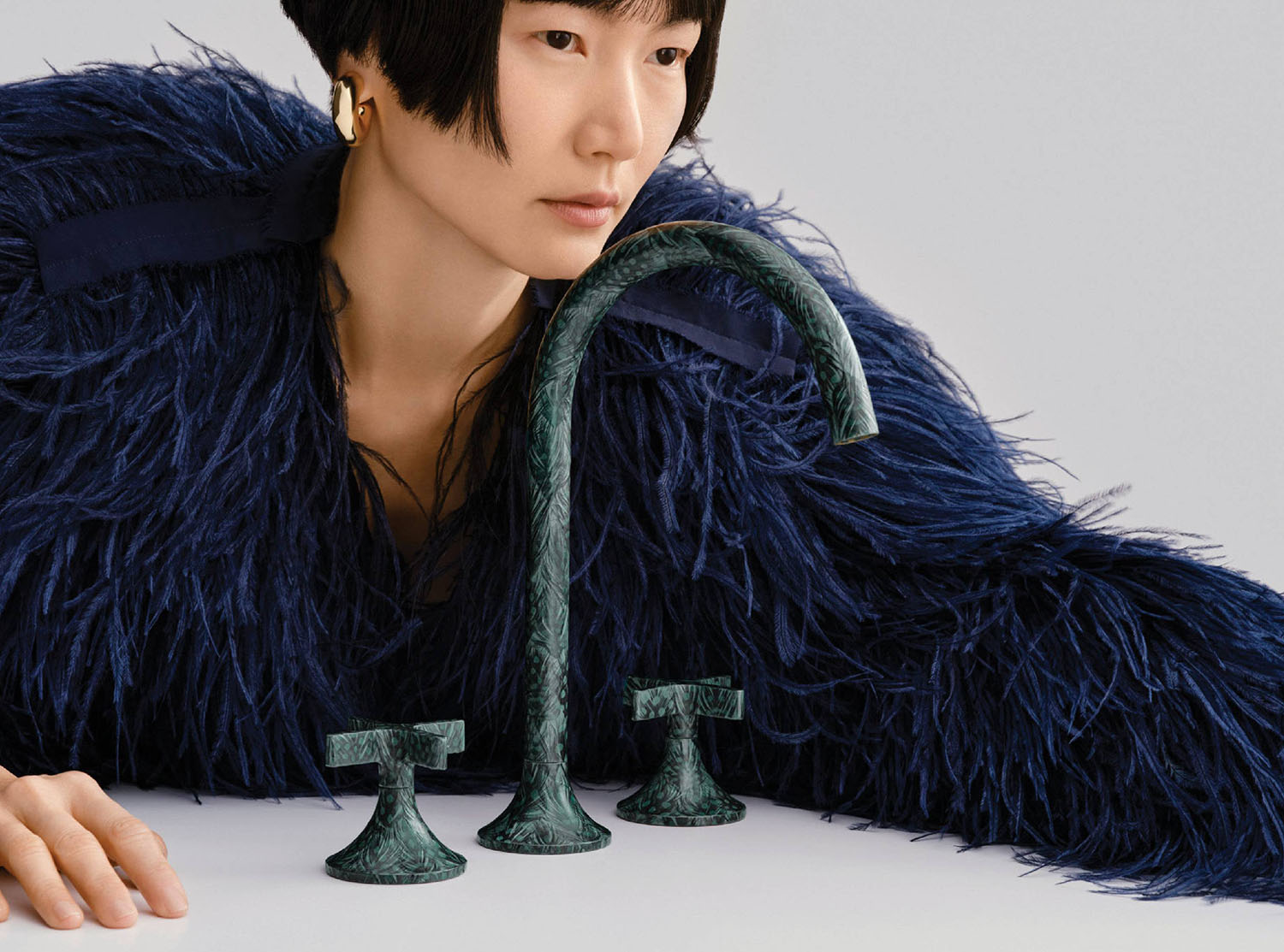 A woman in a blue feathered jacket.