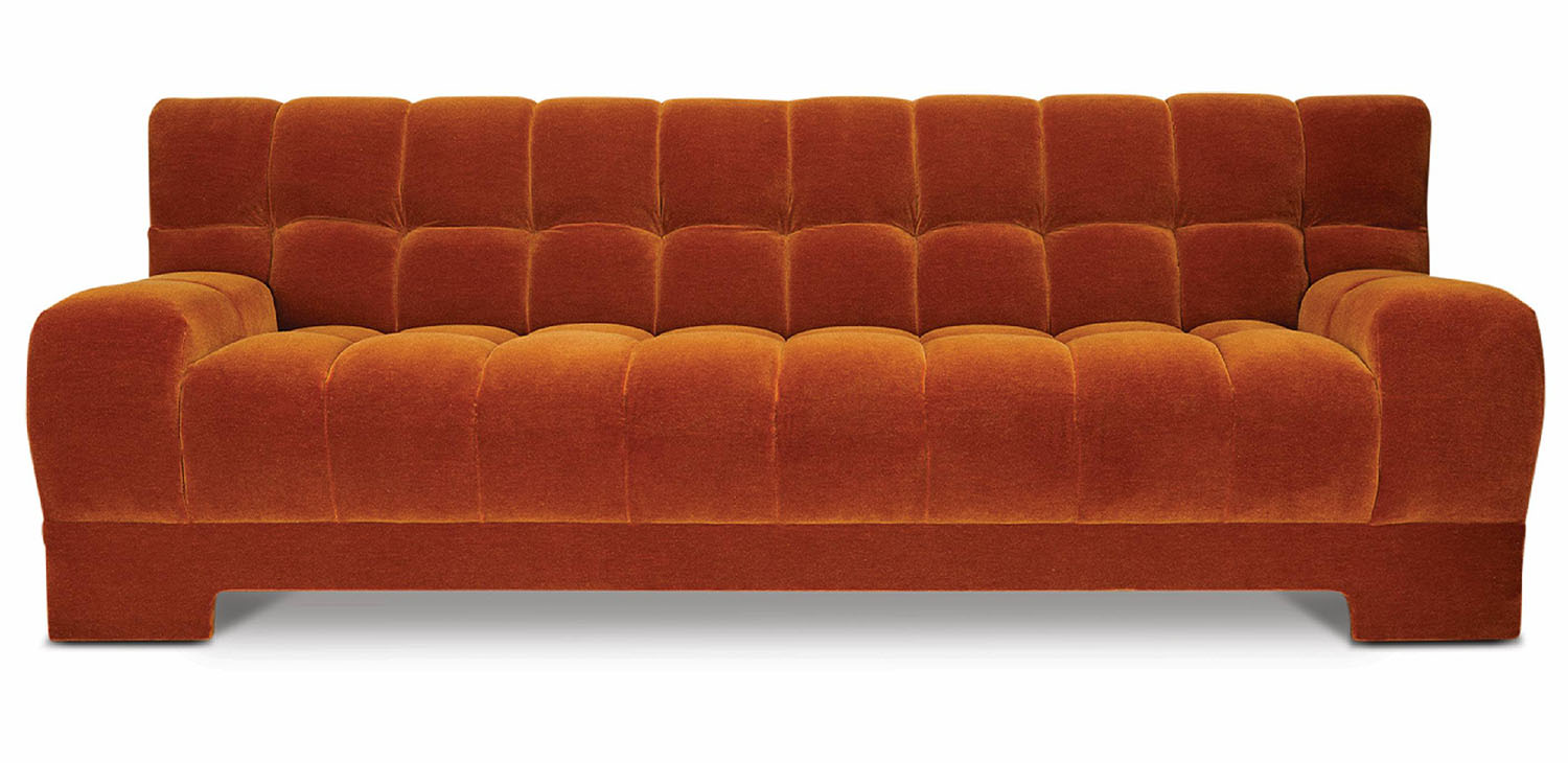 A couch with a brown velvet upholing.