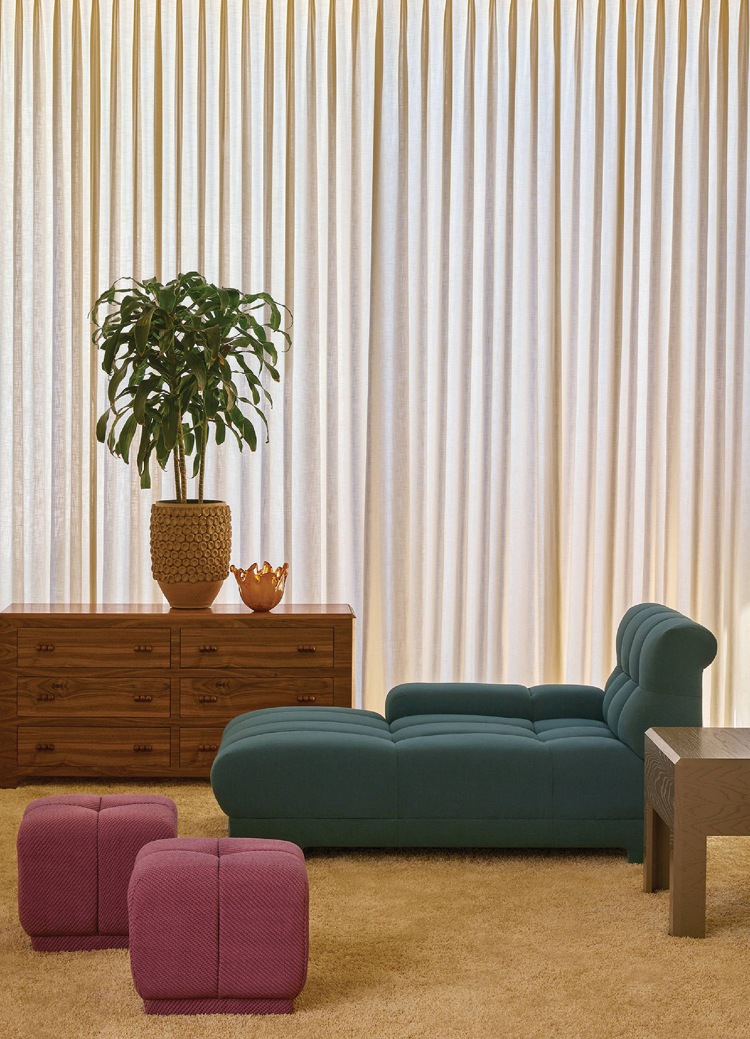 A living room with a couch, chair, and a plant.