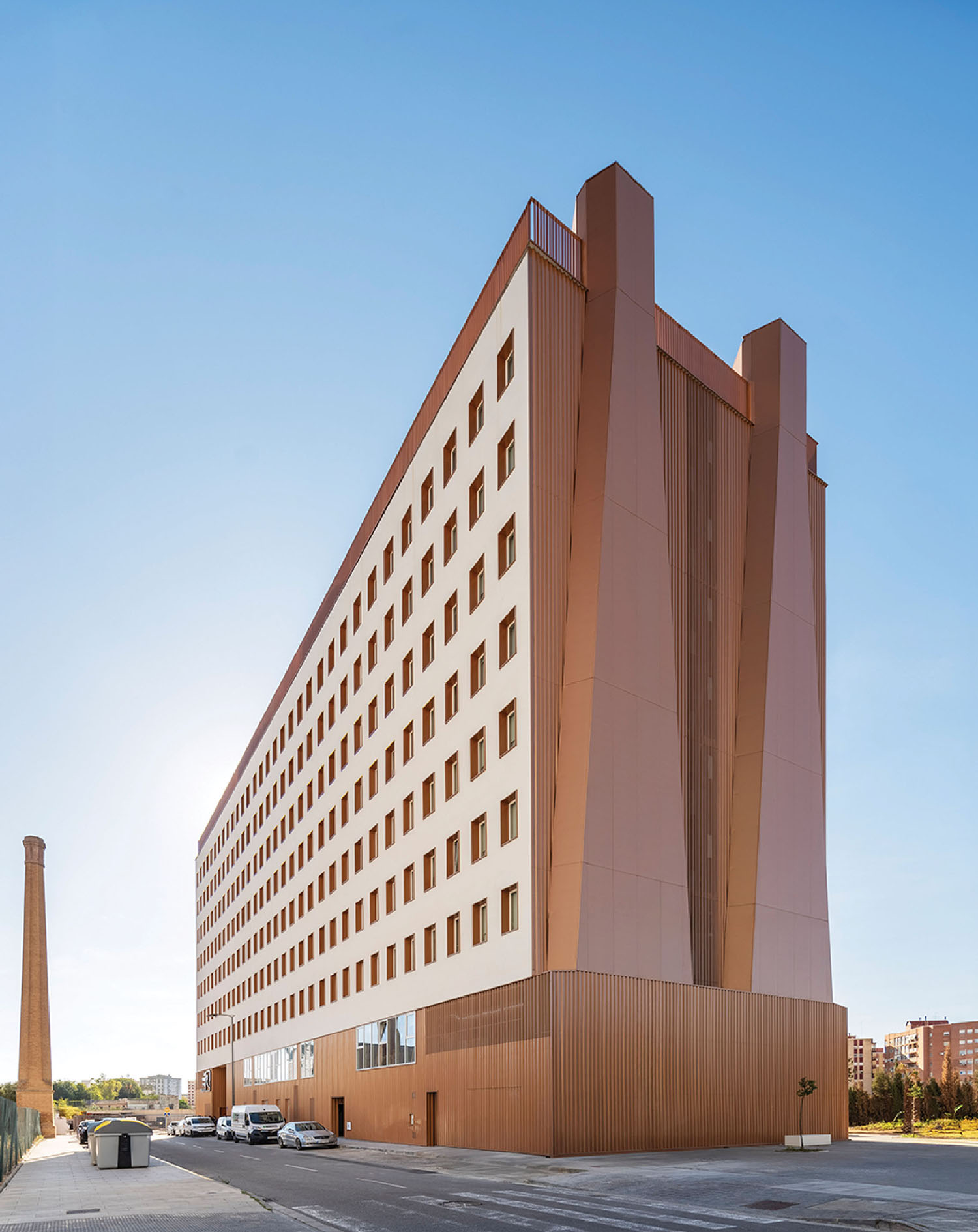 a large building with a long, copper colored facade