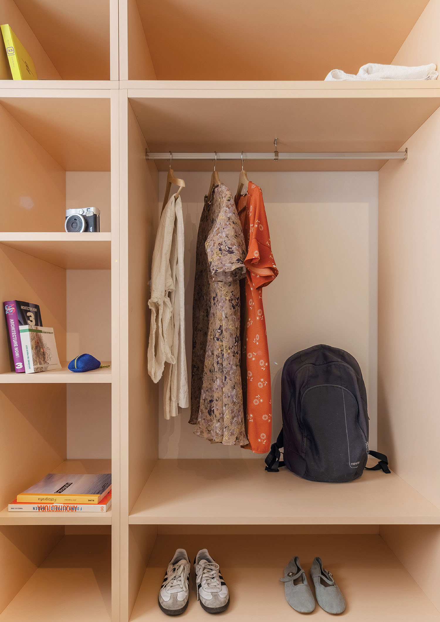 a closet with a backpack and shoes