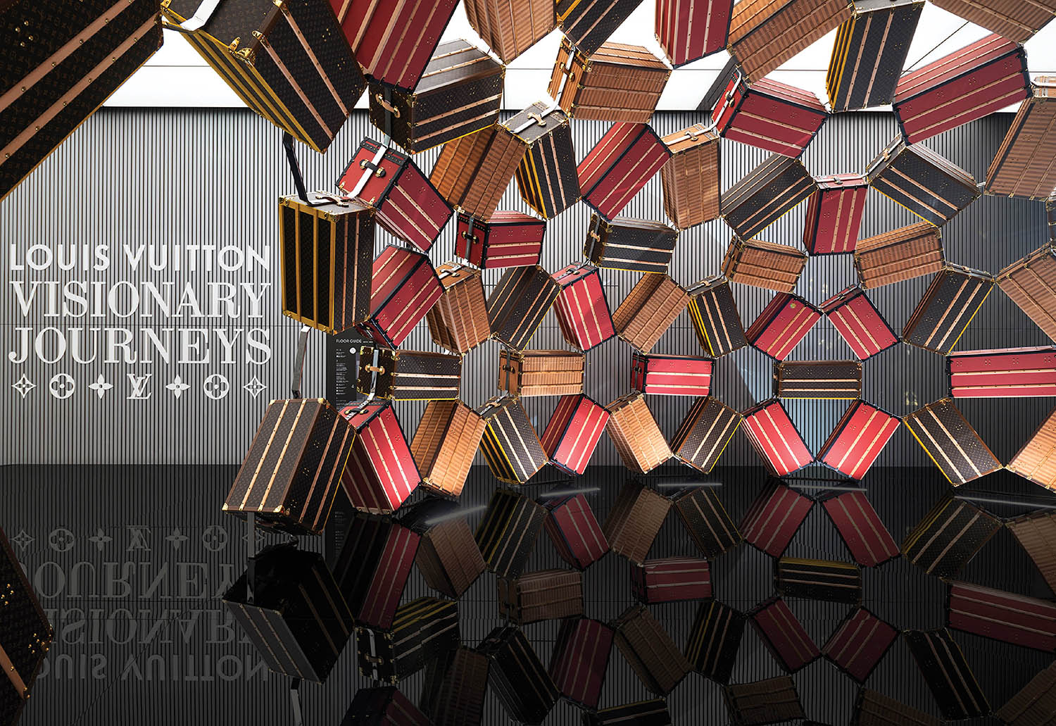 A large display of wooden pieces with a sign that says louis vui.