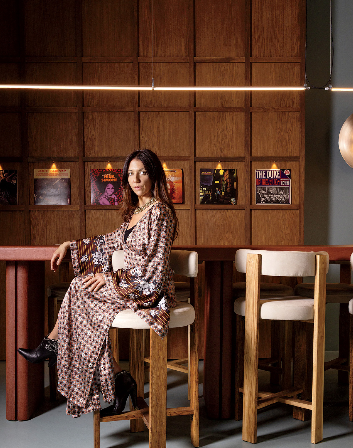 A woman sitting at a table with a guitar