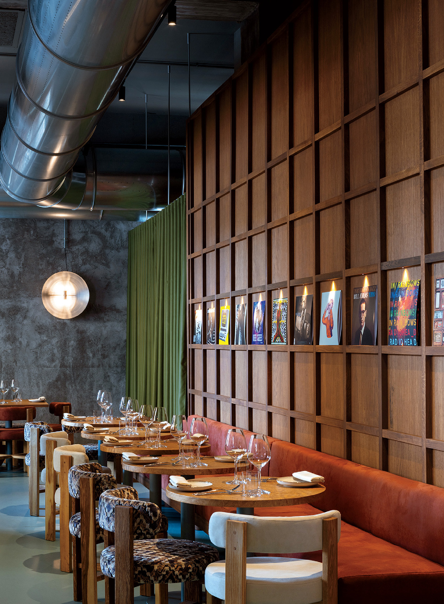 A restaurant with a long table and a long wall of wood