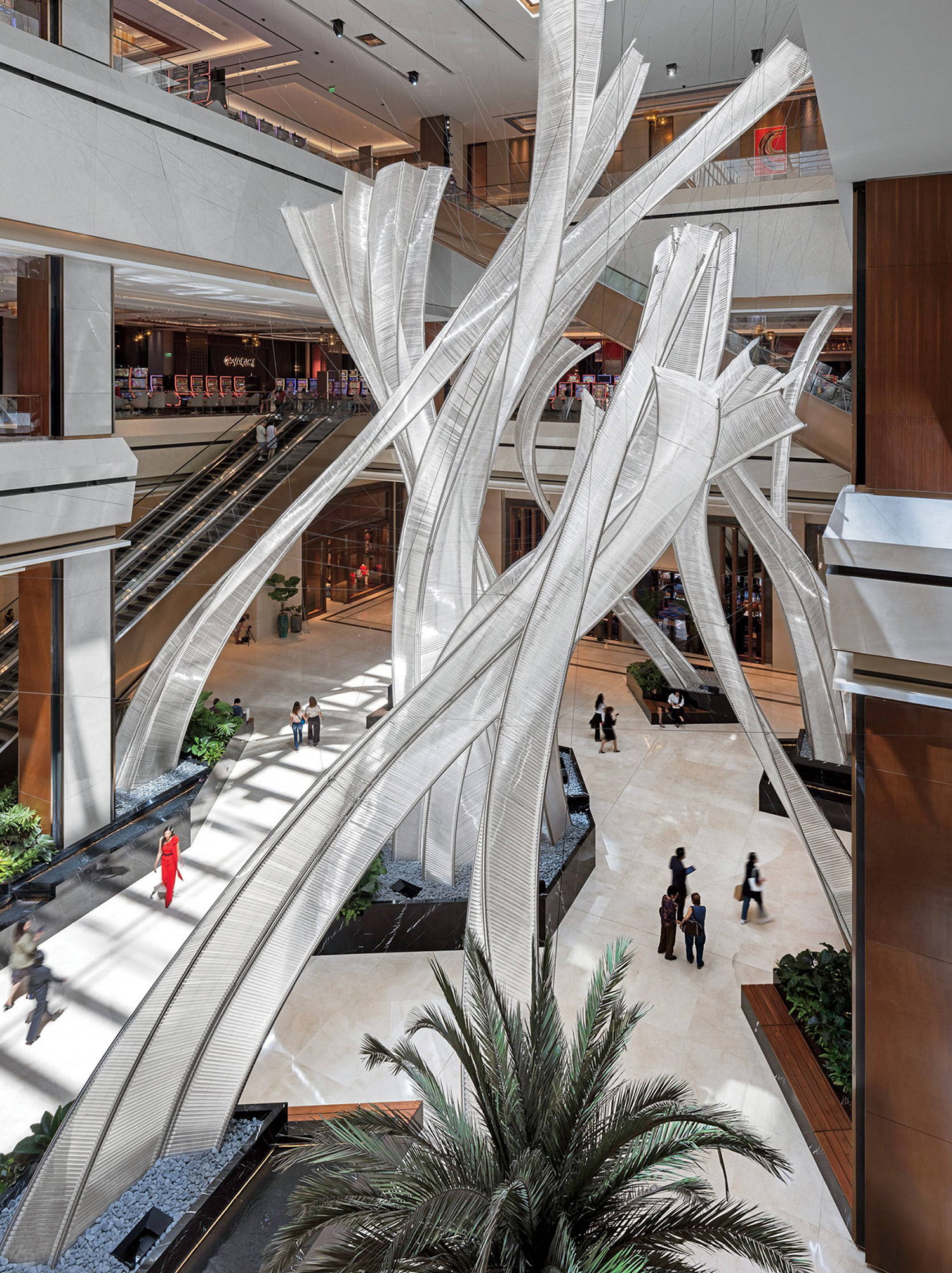 A large atrium with a palm tree in the center