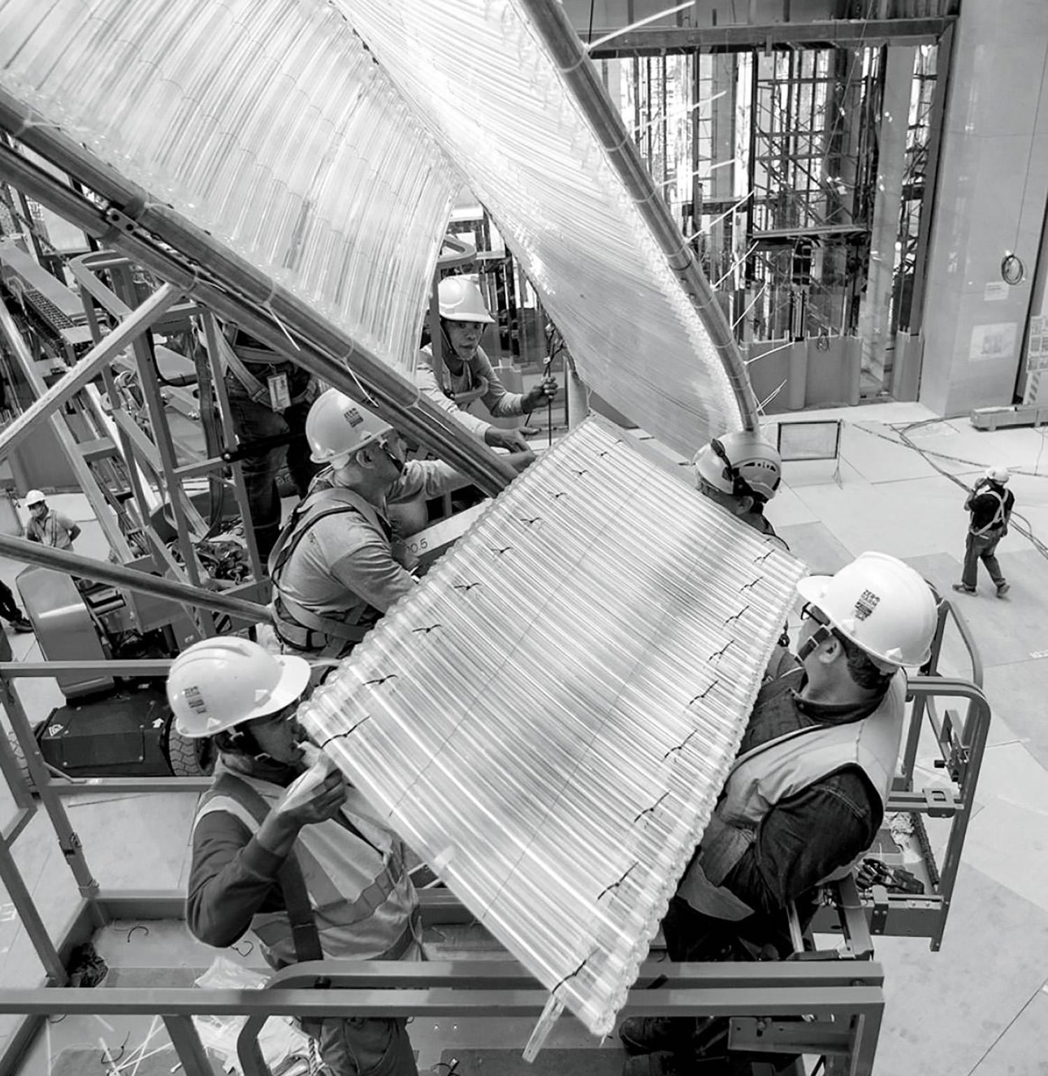 A man working on a metal sheet in a factory