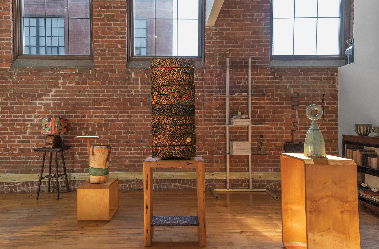 A room with a brick wall and a wooden table